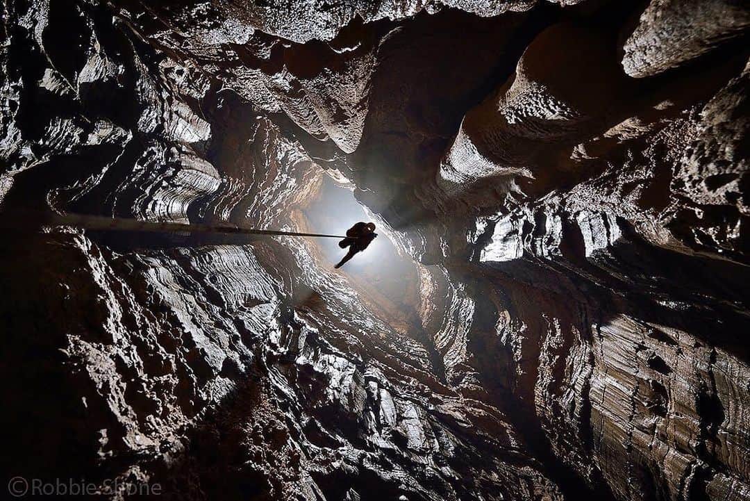 thephotosocietyさんのインスタグラム写真 - (thephotosocietyInstagram)「Photo by Robbie Shone @shonephoto | North of the Wujiang River in Wulong county, China, the mountains that surround the small town of Tongzi are riddled with immense cathedral-like caverns and deep vertical pits that seem to go on down forever. This vast area of limestone awaits any intrepid explorer. Light shines all around an American explorer (pictured) as he climbs the rope he installed in the centre of this epic cave shaft known as Xinu Attic.」8月30日 21時15分 - thephotosociety