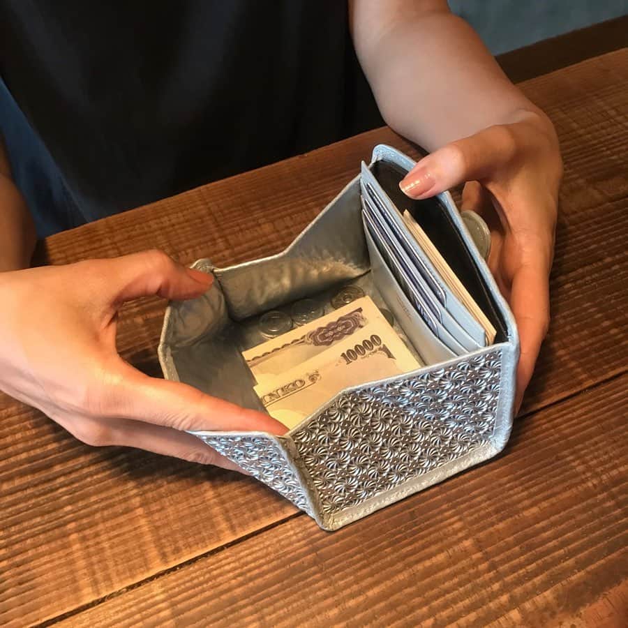 ヒロコハヤシさんのインスタグラム写真 - (ヒロコハヤシInstagram)「#ヒロコ財布部﻿ ﻿ 親しい間柄の知人や友人の財布を見る機会はたくさんあっても、中身をこんな風に使っているという情報は意外と知らないもの。﻿ ここでは#ヒロコハヤシ の財布を自分らしく使っている人を紹介していきます。﻿ ................﻿ ≡Report NO.010 ≡ 作詞家/コピーライター ﻿ 大塚ミク﻿ ﻿ 『 長財布派が“MINIMO”にトライ。大きくもない、小さくもない絶妙なサイズ感』﻿ ﻿ .................﻿ いつもは長財布派だけど、小さい財布も気になっている皆さまに朗報です。﻿ ﻿ ヒロコ ハヤシの長財布愛用者からも、「あったらいいのに！」と熱望されていた、﻿ 新しいサイズ感の財布“MINIMO”（ミニモ）が﻿ 発売しました。﻿ ﻿ 今回は作詞家でコピーライターの大塚ミクさんに、発売前にお試ししてもらい、レポートしていただきました。﻿ ................﻿ ﻿ ◆サイズダウンして、身軽に。﻿ ﻿ もう10年以上、長財布派の私としては、財布を小さくするということ自体が考えられなかったのですが、﻿ 数人の友人が愛用（溺愛）しているHIROKO HAYASHIの新作ということで、トライさせていただきました。 ﻿ ﻿ 第一印象は、「小さすぎない」でした。大きくもない、小さくもない、絶妙なサイズ感。﻿ そして何と言っても、他では見たことのないデザイン。初めての手触り。折り紙みたい！﻿ ﻿ さっそく財布の中身を移し替えてみました。﻿ もともとそんなにパンパンにしているつもりはなかったのですが、全部出してみると意外とある…。﻿ ﻿ とくにカード類が、病院の診察券とか、図書館のカード、子どもの保険証など、いつの間にか増えていて20枚くらい入っていました。﻿ これを精査して10枚に絞り、お札と小銭を入れてみて驚いたのは「軽い！」ということ。﻿ 今まで使っていた財布が、実はかなり重かったことに気づきました。﻿ ﻿ 財布だけでも結構な重量がある上に、大きいと色々入るので、ますます重くなる。﻿ 少し前に腱鞘炎になった時に、財布が重くて辛かったことを思い出しました。軽いって、大切な機能なんですね。﻿ ちょうど出張前だったので、カードを最小限にし、その代わりに名刺を入れてみたところ、荷物自体も軽くなって非常に快適でした。 ﻿ ﻿ ﻿ ◆仕切られすぎない、自由な箱。﻿ ﻿ スナップを開けると、ぱかっと開いて小銭が見渡せる。意外と中が広い。﻿ 仕切られすぎていないところが“自由な箱”という感じで私は好きです。﻿ ただ右利きなので、スナップを右手で外すと、小銭を左手で出さなければいけなくなり、﻿ そのたびにくるっと回転させていました。﻿ でもスナップを左手で外すようにすれば、そのままスムーズに右手で小銭を出せることがわかり、﻿ やっているうちに数日で慣れました。 ﻿ ﻿ ◆所作までも、エレガントに。﻿ ﻿ 使いながら最も感じたのは、クラッチバッグのような高揚感。﻿ 現在3才の息子がいるため、最後にヒールを履いたのはいつだっけ…と、﻿ 出産前を懐かしく思い出しました。﻿ さらに、財布を使う時の一連の手の動きまでも﻿ 計算されているところがすごい。﻿ お金を払っているだけなのに、﻿ なぜかエレガントに見えるんです。﻿ ﻿ 普段のバッグは、保育園用の大きなトート。﻿ 保育園に送ったあと買い物用のエコバックとしても使っていて、いつの間にかこれがメインになってしまいました。﻿ でもお財布って、ほぼ毎日使うもの。おしゃれは、もちろん見てくれる誰かのためでも﻿ あるけれども、一番それを目にするのは、﻿ 自分自身。﻿ ﻿ たとえいつものスーパーであったとしても、好きなデザインであること、自分の所作が﻿ 美しく見えることが、自分自身にプラスの影響を与えてくれる。気分が上がる。﻿ とくに子育て中は、日常の中にそんなエッセンスがあると、違ってくる気がします。﻿ ﻿ ﻿ あとは、ポケットに入るのが嬉しい！小さい子どもがいると、さっと手をつないだり、﻿ やたらと荷物が多くて、何かと手が足りません。﻿ ﻿ 長財布だと片手がふさがってしまうけれど、ポケットに入ると、ちょっと買い物という時に﻿ わざわざ大きなバッグを持っていかなくてもいいのが助かります。﻿ レシートがたまると目につくけれど、それをすぐに整理できるという良さもある。﻿ ﻿ カードもそんなに持ち歩く必要がなかったことがわかり、結果的に、“MINIMO”ひとつで充分、﻿ 使い分け用の財布も要らないことがわかりました。﻿ ................﻿ 財布を変えることで、﻿ カードの量を減らし身軽になれたという、大塚さんの「使い方」。﻿ 自分自身の意識すらも変えてくれる“MINIMO”をぜひチェックしてみてくださいね。﻿ ﻿ ◆写真﻿ ④クラッチ気分で持てるのがうれしい﻿ ⑤保育園の通園用トート。中にはオムツ、おしりふき、着替え、水筒など。﻿ ﻿ ◆大塚ミク﻿ 作詞家／コピーライター﻿ 「孤独を共感に変える」をテーマに、コピーライティング、作詞、詩、エッセイ、絵本など多方面で活動中。出雲在住、3歳児の母。 ﻿ ﻿ @miku_otsuka﻿」9月6日 11時32分 - hiroko_hayashi_official