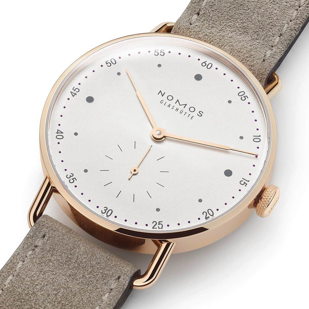 ノモスさんのインスタグラム写真 - (ノモスInstagram)「NOMOS bestseller Metro welcomes a fine new family member: in rose gold and with a smaller diameter. Gray hour markers and delicate violet minute markers on the white silver-plated dial combine harmoniously with the rose gold case and hands. The perfect finishing touch? The soft, beige-colored velour leather strap with golden NOMOS winged clasp.  #nomos #nomosmetro #watch #watches #watchesofinstagram #watchfam #watchuseek #watchmania #goldwatch #dresswatch #glashutte #watchlove #watchlover #newwatch #clock #horology #timepiece #timepieces @studio.mark.braun」9月12日 19時25分 - nomos_glashuette