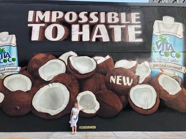Vita Coco Coconut Waterのインスタグラム：「Meet Britt, our media gal.  Here she is standing in front of this summer's billboard. Fun fact:  today's her birthday.  Everyone say happy birthday to Britt.」