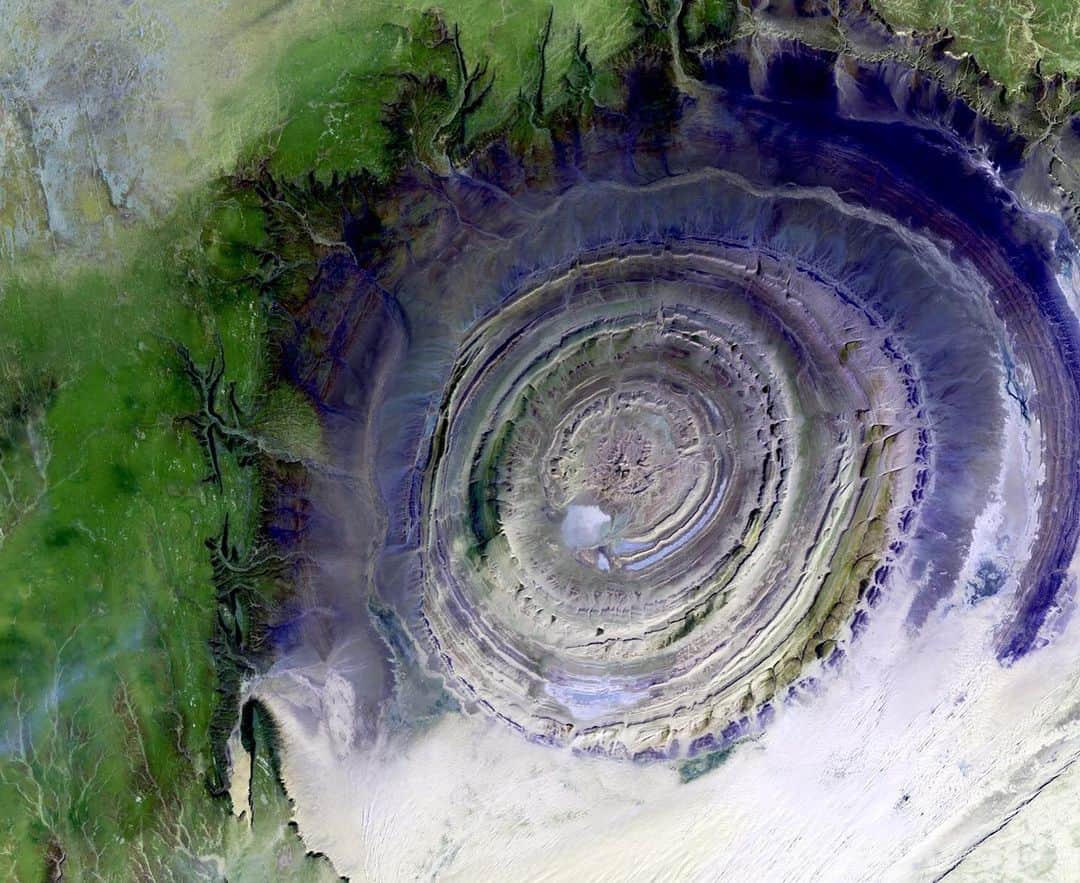 NASAさんのインスタグラム写真 - (NASAInstagram)「"The living history of the Earth jumps out at you through buckles, folds, giant fans," wrote astronaut Nick Hague (@astrohague) about his photo of the "Eye of the Sahara" from the International Space Station (@ISS). Scroll through for more images of this striking geologic feature, the Richat Structure of Mauritania, captured by astronauts on the station and @NASAEarth satellites. ⁣ ⁣ Located in the Sahara Desert, it measures 28 miles (45 kilometers) across and is made up of igneous and sedimentary rocks. It's thought to be caused by an uplifted dome that has been eroded to expose the originally flat rock layers.⁣ ⁣ #mauritania #sahara #desert #richatstructure #geology #earthart #spaceart⁣ ⁣ 1) Photograph taken from the International Space Station, Sept. 2019. The image has been enhanced to improve contrast.  Image Credit: NASA⁣ 2) ASTER Mission image from Oct. 7, 2000. Image Credit: NASA/METI/AIST/Japan Space Systems and U.S./Japan ASTER Science Team⁣ 3) Landsat satellite image draped over an elevation model produced by the Shuttle Radar Topography Mission (SRTM); February 2000 (SRTM), January 13, 1987 (Landsat). Image Credit: SRTM Team NASA/JPL/NIMA⁣ 4) Landsat-7 satellite image from Jan. 11, 2001. Image Credit: NASA/U.S. Geological Survey/Landsat-7/Goddard Space Flight Center⁣ 5) Photograph taken from the International Space Station, Dec. 17, 2011. Image Credit: NASA」9月18日 4時15分 - nasa