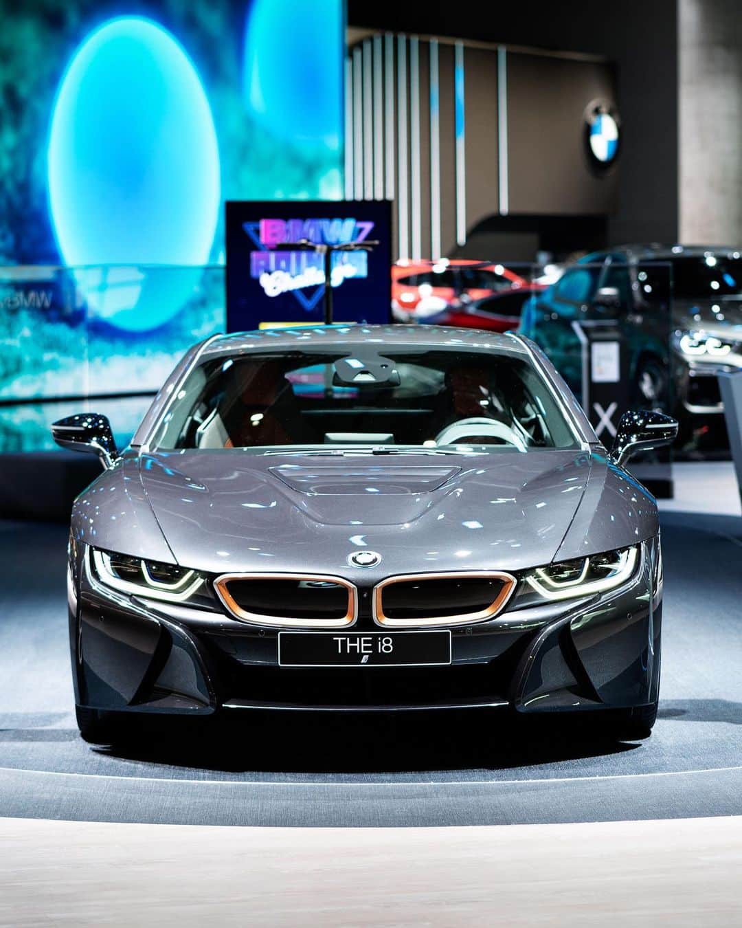 BMWのインスタグラム：「Exclusive touches raise sporting presence to a new level.  Meet the BMW i8 Coupé Ultimate Sophisto Edition at #IAA19 in Frankfurt. #THEi8 #BMW #BMWi8 #BMWIAA @BMWi @BMWdeutschland __ BMW i8 Coupé: Energy consumption in kWh/100 km (combined): 14.0. Fuel consumption in l/100 km (combined): 1.8. CO2 emissions in g/km (combined): 42.  Acceleration (0-100 km/h): 4.4 s. Power: 275 kW, 374 hp, 570 Nm. Top speed (limited): 250 km/h. Paint finish shown: Sophisto Grey Brilliant Effect with highlight E-Copper.  The values of fuel consumptions, CO2 emissions and energy consumptions shown were determined according to the European Regulation (EC) 715/2007 in the version applicable at the time of type approval. The figures refer to a vehicle with basic configuration in Germany and the range shown considers optional equipment and the different size of wheels and tires available on the selected model. The values of the vehicles are already based on the new WLTP regulation and are translated back into NEDC-equivalent values in order to ensure the comparison between the vehicles. [With respect to these vehicles, for vehicle related taxes or other duties based (at least inter alia) on CO2-emissions the CO2 values may differ to the values stated here.] The CO2 efficiency specifications are determined according to Directive 1999/94/EC and the European Regulation in its current version applicable. The values shown are based on the fuel consumption, CO2 values and energy consumptions according to the NEDC cycle for the classification. Further information on official fuel consumption figures and specific CO2 emission values of new passenger cars is included in the following guideline: 'Leitfaden über den Kraftstoffverbrauch, die CO2-Emissionen und den Stromverbrauch neuer Personenkraftwagen' (Guide to the fuel economy, CO2 emissions and electric power consumption of new passenger cars), which can be obtained free of charge from all dealerships, from Deutsche Automobil Treuhand GmbH (DAT), Hellmuth-Hirth-Str. 1, 73760 Ostfildern-Scharnhausen and at https://www.dat.de/co2/.」