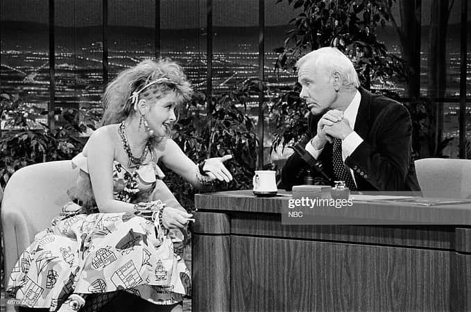 シンディ・ローパーさんのインスタグラム写真 - (シンディ・ローパーInstagram)「Johnny Carson was huge for me. Although he always called me Sydney and never Cyndi. But hey, it was Johnny Carson, and that was his pet name for me, which was kind of cool. When I first went on his show, I wore the sparkly, full skirt I wore in the “Time After Time” video and this wonderful rust-and-yellow Hawaiian- print shirt that I loved (I still have it), and I tied tulle around my head in a bow. I saw that tulle on a mannequin named Esther at Screaming Mimi’s first. My friend Biff Chandler, who was Laura’s partner at Screaming Mimi’s, came up with that idea. (Sadly, he died of AIDS in the nineties. At that time, we were losing a lot of visionaries to AIDS.) All the mannequins had names. And I thought, “Wow, that tulle is good.” (My hair never seemed big enough for me; I always felt like I was this small person.) And I brought Johnny a pair of sunglasses. He said to me, “You dress so unusual.” I said, “Really? Because it doesn’t seem that way to me. I think you dress very unusual.” #nationaltvtalkshowhostday #happybirthdayjohnnycarson 📺」10月24日 4時10分 - cyndilauper