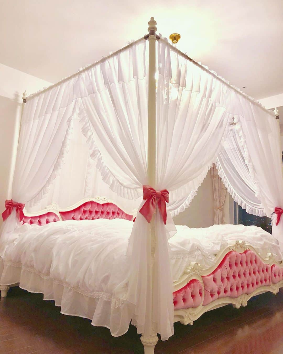 寿リリカさんのインスタグラム写真 - (寿リリカInstagram)「♡ 他のお部屋も見たいとリクエスト頂いていたので、bedroomの天蓋ベッドをどうぞ❤️🎀❤️ ♡ キングサイズよりも大きい特別サイズをオーダーして、イタリアで半年間くらいかけて作ってもらったの🇮🇹 テレビ収録にも雑誌撮影にも残念ながら完成が間に合わなかったから初公開だよ💕💕 ♡ ピンクのベロア素材でカーテンタッセルのリボンもおそろいに作ってもらったの🎀😍🎀 ♡ ベッドルームまで私好みの幸せ気分になるインテリアで揃えてくれた主人に感謝😭💓 別室の主人の書斎室だけはシックだよ💻✨ ♡ #myhome #bedroom #bed #ベッドルーム #天蓋ベッド #白家具 #輸入家具 #ウエストハウスギャラリー #オーダーメイド家具」10月7日 18時58分 - ririkakotobuki