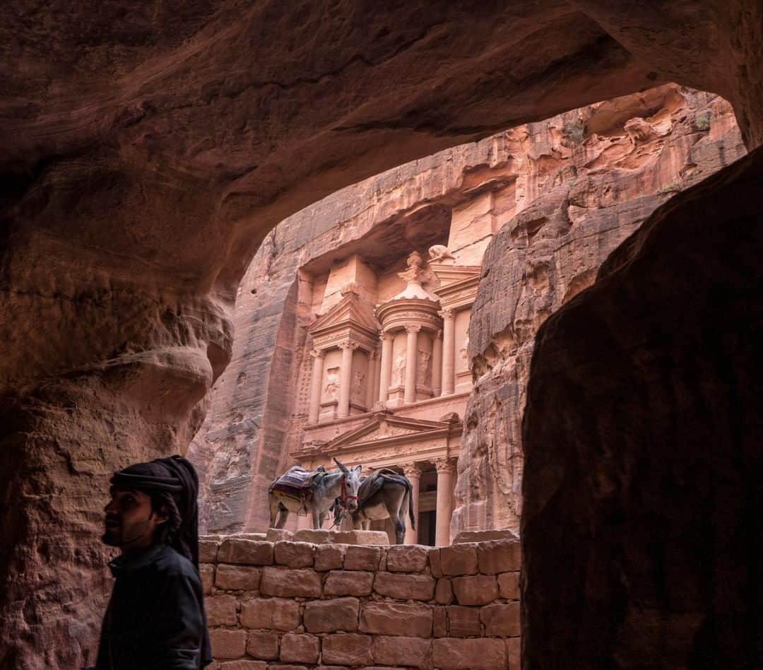 National Geographic Travelさんのインスタグラム写真 - (National Geographic TravelInstagram)「Photo by Muhammed Muheisen @mmuheisen | Seen through a tomb in Petra, Al-Khazneh (Arabic for “the treasury”) is one of many facades carved into the mountains of this ancient city in Jordan. For more photos and videos from different parts of the world, follow me @mmuheisen and @mmuheisenpublic. #muhammedmuheisen #jordan」10月9日 1時07分 - natgeotravel