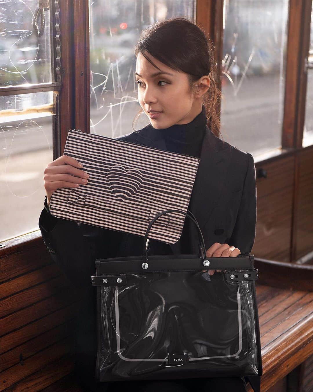 フルラさんのインスタグラム写真 - (フルラInstagram)「Yours in a heartbeat.  A behind-the-scenes look at the Furla Fall Winter 2019 campaign shot in Milano. This Furla Lady M variant is a bag-in-a-bag, with the body in clear PVC and the iPad case in classic black printed calf leather.  #thefurlasociety #furlafeeling #newcollection #furla #accessories #fashion」10月13日 19時12分 - furla