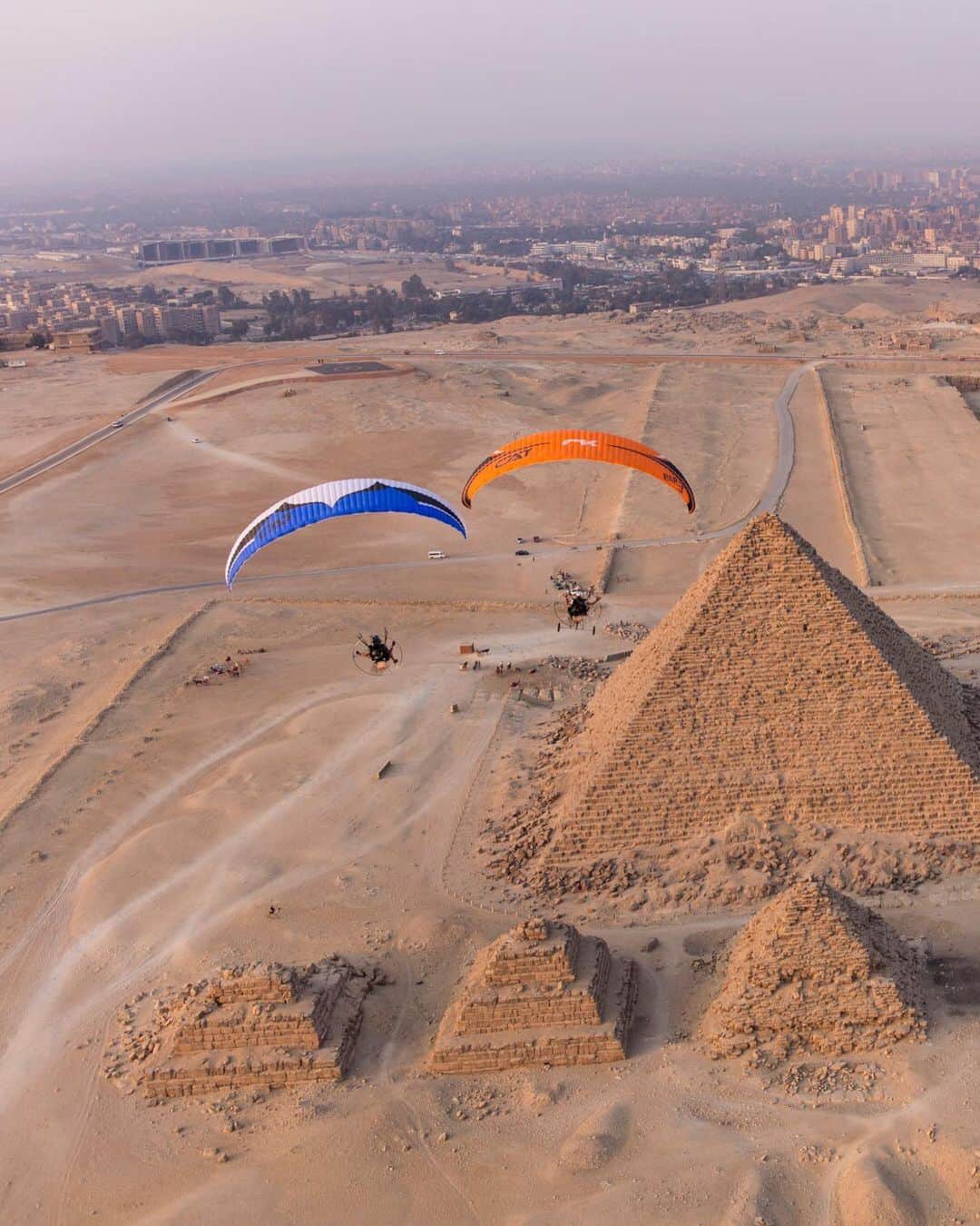 National Geographic Travelさんのインスタグラム写真 - (National Geographic TravelInstagram)「Photo by George Steinmetz @geosteinmetz | Four-time Paramotor World Champion Ramon Morillas and his protégé Nicolas Aubert have big fun over the Pyramids of Giza. To explore more of our world from above, follow @geosteinmetz. #paramotor #paragliding」11月14日 2時10分 - natgeotravel