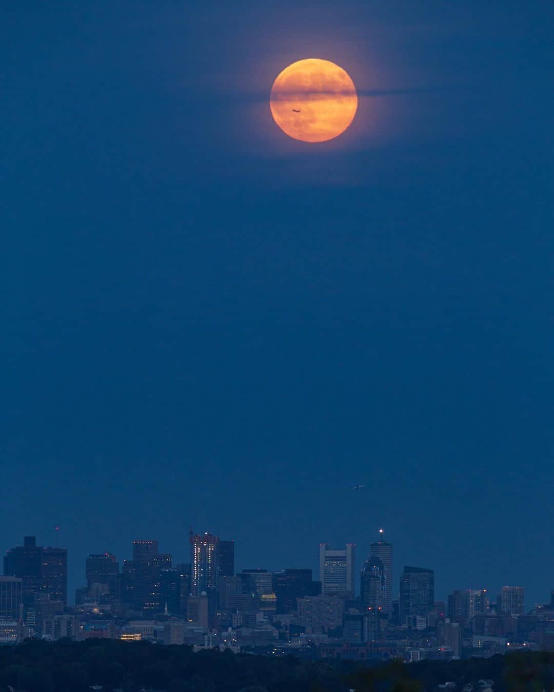 National Geographic Travelさんのインスタグラム写真 - (National Geographic TravelInstagram)「Photos by @BabakTafreshi | On an autumn night in Boston, the full moon rises above the city's skyline during the blue hour. Swipe for a closer look at the moon and an airplane flying from Logan International Airport. #boston #newengland #fullmoon #bluehour #twanight」11月14日 6時04分 - natgeotravel