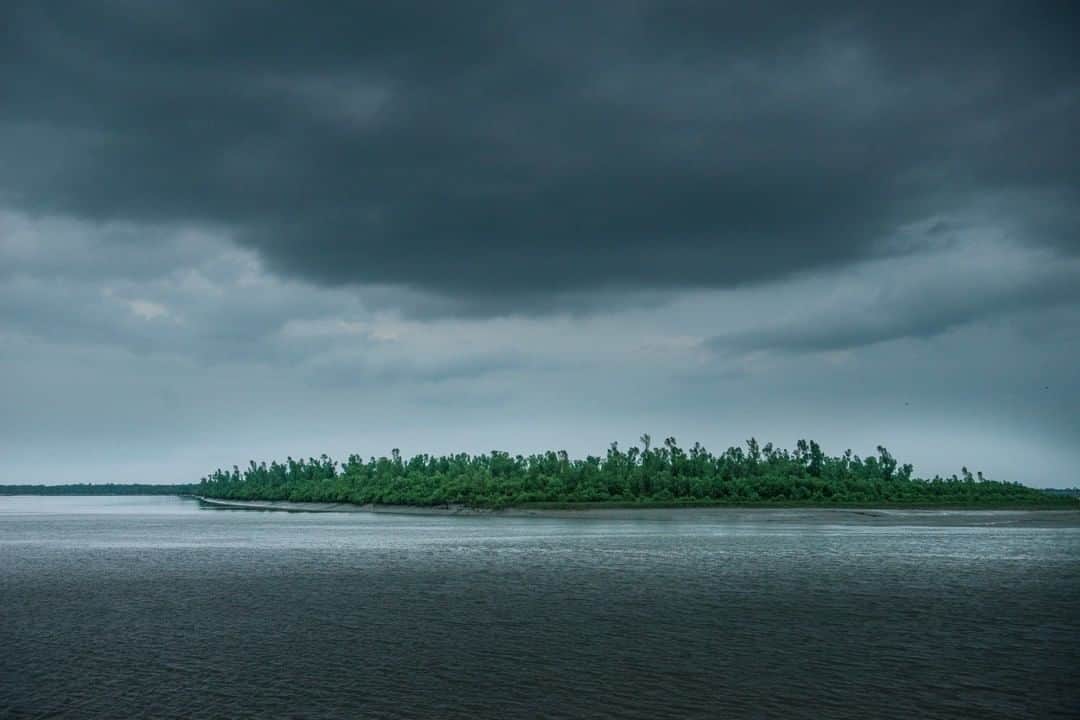 のインスタグラム：「Photo by @ismailferdous | The Sundarbans area is indisputably the largest mangrove forest on Earth, and it lies in the world's biggest river delta, formed by the convergence of the Ganges, Brahmaputra, and Meghna Rivers in the Bay of Bengal. This national forest spreads across 3,861 square miles in  Bangladesh and India (60%  in Bangladesh), and it's home to many rare and globally endangered wildlife species, such as the royal Bengal tiger. In two major ways, the Sundarbans is being impacted by climate change: first, the sea level is rising,  flooding lands with each high tide. When the tide retreats, the land is left more saline than before—and less able to grow crops. The same goes for the brackish creeks and river mouths dotting the forests. The second consequence: more big cyclones. Higher seas give the cyclone winds greater velocity, and the area has been hit by catastrophic cyclones in the previous years. #Climatechange #RoyalBengalTiger」