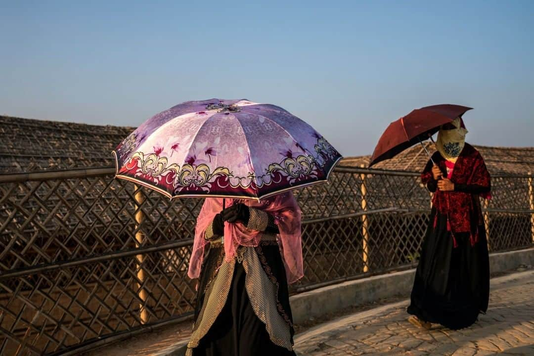 ナショナルジオグラフィックさんのインスタグラム写真 - (ナショナルジオグラフィックInstagram)「Photo by Nichole Sobecki @nicholesobecki | Two friends walk together through Kutupalong camp in the far southeast of Bangladesh, where nearly a million Rohingya refugees live after fleeing persecution in neighboring Myanmar (Burma). Their umbrellas made me think of shields, protecting them from the harsh sun but also from the fragility of life in the world’s largest refugee camp. #women #refugee #rohingya #bangladesh  Nat Geo is celebrating women who fearlessly push boundaries and inspire the next generation of changemakers. For a week, all of our posts and stories on @natgeo were photographed by women, about women. Use #NatGeoWomenofImpact to share how a woman in your life has empowered you.」10月27日 19時39分 - natgeo