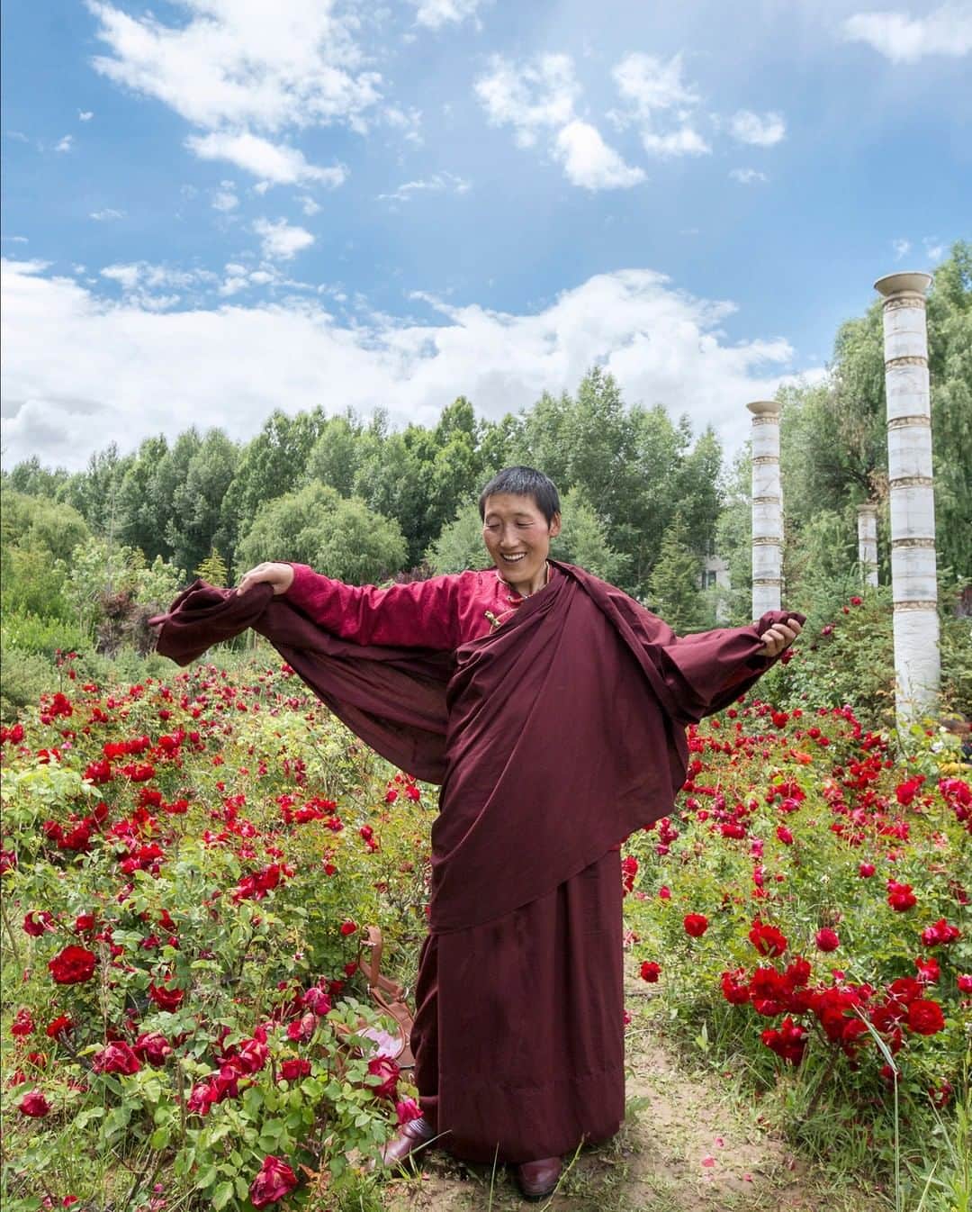 National Geographic Travelさんのインスタグラム写真 - (National Geographic TravelInstagram)「Photo by @andrea_frazzetta | A nun on a pilgrimage to the Potala Palace stands in the beautiful gardens surrounding the palace. Buddhist monks and worshippers come to Lhasa from all over Tibet to pray at this sacred site. The pilgrimage to the Potala Palace, once the Dalai Lama residence, is a fundamental ritual in the life of a Tibetan Buddhist. With its fairy-tale temples, snowcapped peaks, and a population that radiates spirituality, Tibet is a near-mythical travel destination.  To see more photos from my travels, follow me @andrea_frazzetta. #lhasa #tibet」10月27日 21時07分 - natgeotravel