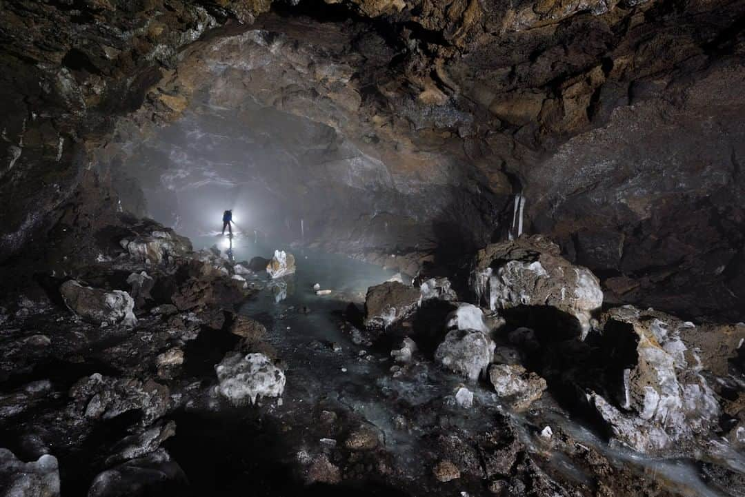 National Geographic Travelさんのインスタグラム写真 - (National Geographic TravelInstagram)「Photo by Robbie Shone @shonephoto | While thick fog swirls around outside on Mount Etna, an explorer admires a frozen lake in the misty subsurface of Grotta del Gelo. The lava tube formed following the cooling of a lava flow from an eruption that began in July 1614 and lasted for over 10 years. Grotta del Gelo is unusual, as finding lava tubes with ice inside is a rarity. #italy」10月29日 17時09分 - natgeotravel