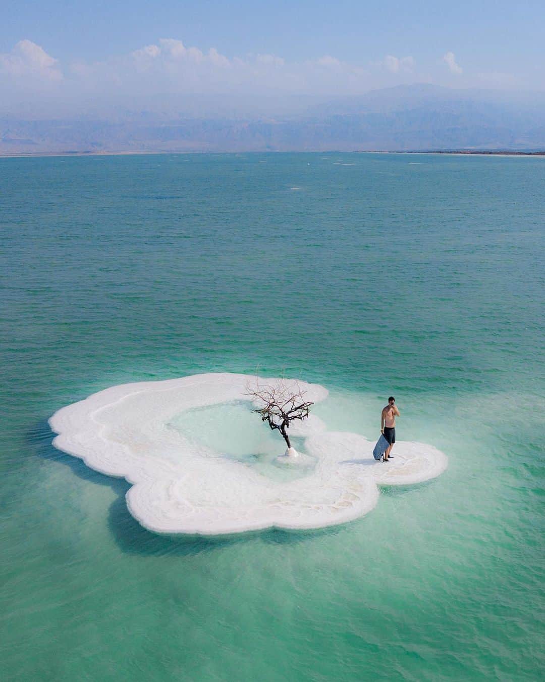 ティモシー・サイクスのインスタグラム：「It’s the weekend so I don’t always have my laptop with me, sometimes I just chill and enjoy my surroundings! I swam back to this crazy little island made entirely of salt in the Dead Sea in Israel a few times, taking in its unique views while also thinking about how lucky we are to be living in this amazing time in history filled with more opportunity than ever before. But I often wonder who will capitalize on all their potential and who will just waste it? I’m blessed to have so many incredible people in my life who are following their passion and doing truly inspiring things, but sadly I also know too many talented people who, for whatever reason, aren’t taking advantage of all they have been given and I want to smack them...hard...and get them out of their funk because they are capable of so much more and there’s nothing worse than wasted potential! So...which one are you? How hard are you wiling to make ALL your dreams come true? Think long and hard before you answer as these are two questions that can really change your life over time! #dreambig #buildyourowndreams #deadsea #jewblue」