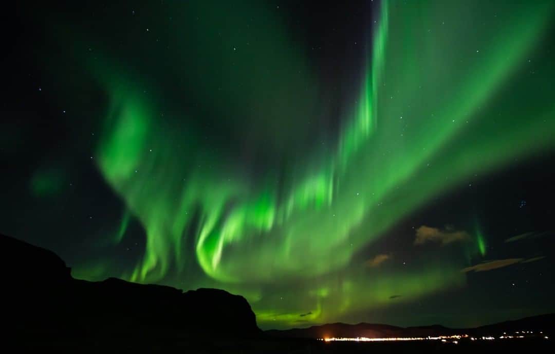 National Geographic Travelさんのインスタグラム写真 - (National Geographic TravelInstagram)「Photo by Ifeoma Ozoma @ifyozoma | Having spent my childhood in Alaska, I took seeing the dancing lights of the aurora borealis for granted until my family moved. I spent 14 days traveling around Iceland, and it wasn’t until my 12th night that the conditions were good enough to witness this display. This image was captured near the town of Hveragerði on a night with around 15 percent cloud cover. I’m used to long nighttime exposures, but the green was so bright and vibrant that even three seconds was more than long enough. For more photos from my time in the land of fire and ice, follow @ifyozoma. #Iceland」11月11日 6時05分 - natgeotravel