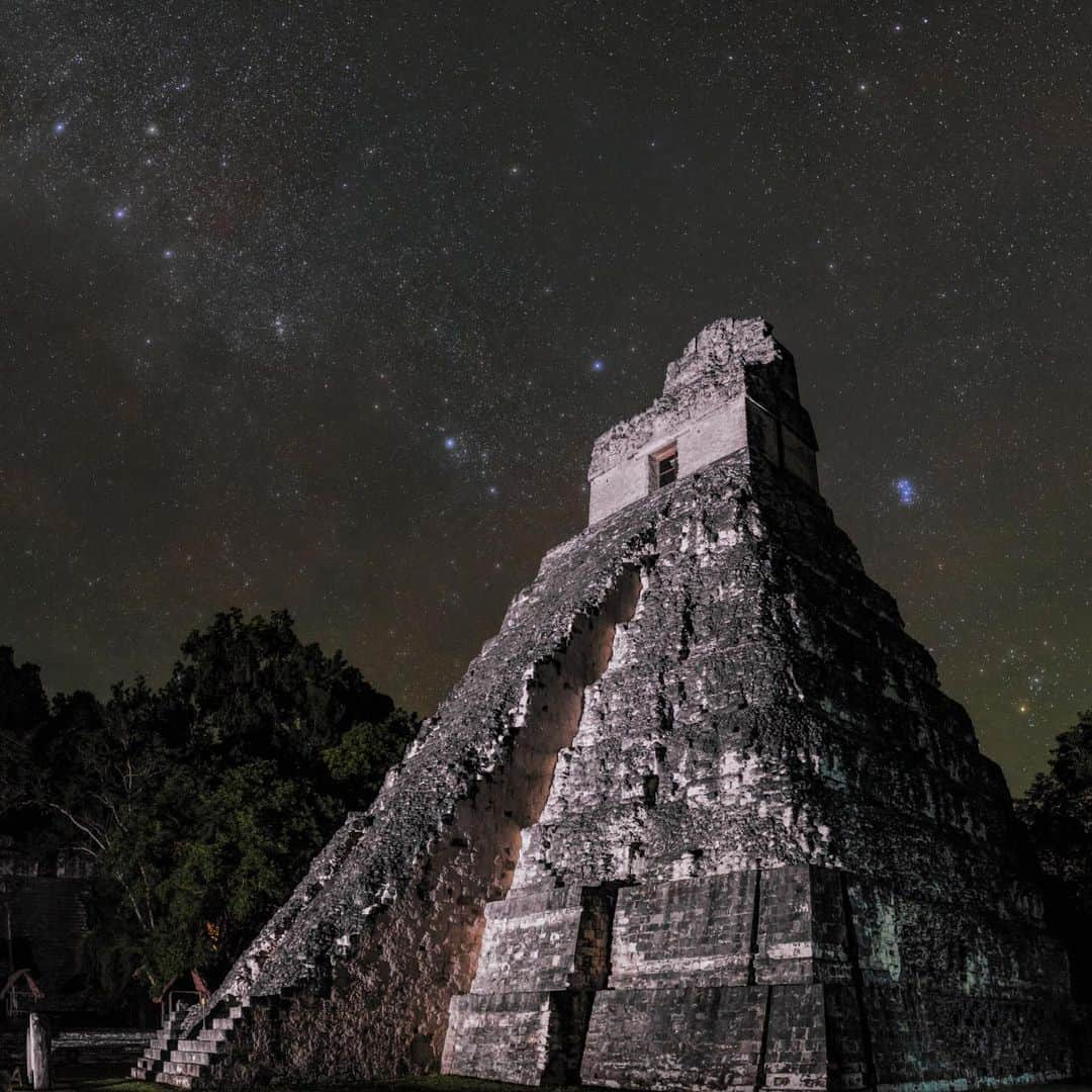 ナショナルジオグラフィックさんのインスタグラム写真 - (ナショナルジオグラフィックInstagram)「Photos by @babaktafreshi | This impressive Maya temple in Tikal is called the Great Jaguar, and you can hear the big cat if you spend enough time in this jungle at night. Protected in a national park in Guatemala, jaguars freely roam around the temples after dark, when tourists have departed. When I visited recently with special permission to document the site at night, the tropical sky had cleared after thunderstorms. Taurus (the bull) and the Pleiades star cluster (also known as the Seven Sisters) were rising above the 47-meter (154 feet) pyramid, which dates to 750 A.D.  There are both old stories and new studies on the importance of the Pleiades to the Maya (swipe for a closer view). One myth is that the people of Tikal believed they came from Pleiades, and the seven important pyramids of the Grand Plaza in Tikal represent the pattern of Pleiades. There is no doubt that some Maya pyramids were built to reflect astronomical events, and from atop Tikal’s pyramids, perhaps ancient astronomers tracked the movements of celestial objects, keeping time for rituals and agriculture. The Maya calendar was one of the most advanced of the ancient world, thanks to astronomical observations. When Pleiades rises at sunset and is visible for the entire night in November, that’s when the dry season and harvesting begin.  Tikal is one of the largest sites of Maya civilization, and at its peak was home to at least 60,000 Maya. Explore more of the world at night with me @babaktafreshi. #tikalnationalpark #saveournightsky #guatemala #maya #twanight」12月13日 0時38分 - natgeo