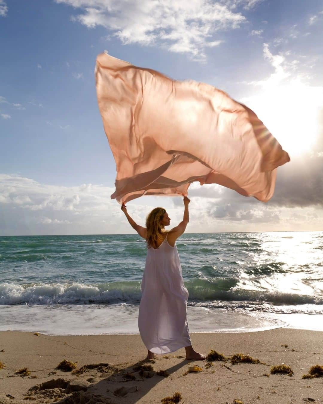 ナショナルジオグラフィックさんのインスタグラム写真 - (ナショナルジオグラフィックInstagram)「Photo by Maggie Steber @maggiesteber | I have always been fascinated by the wind and its purpose in nature. Wind comes and goes, but where does it come from and where does it go? How does it grow in speed and force?  Of course, there are scientific explanations: The sun actually makes the wind and makes it blow. But I like the idea of the wind being mysterious, coming gently out of nowhere to cool us off at night or speeding furiously with a hurricane or tornado. Some Native Americans believe the wind brings warnings or is a thing to avoid. After all, it carries smells so that animals know to run away when we or other predators are nearby. It can be our friend or our enemy.  This photo is part of a personal project in which I try to show wind in unexpected ways. I photographed a friend on a windy morning on Miami Beach, Florida, with a length of satin. I use fabrics and other indicators of wind velocity to find the emotional and physical aspects of wind in various situations. #ngwomenofvision #windproject #women」11月24日 12時35分 - natgeo