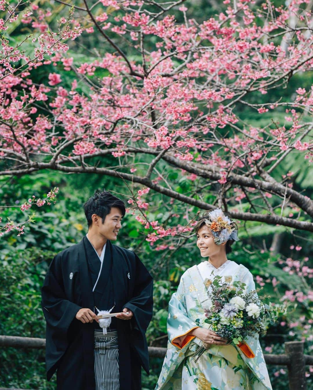 デコルテウエディングフォトグループさんのインスタグラム写真 - (デコルテウエディングフォトグループInstagram)「＼日本一早く開花する"桜"🌸／1月〜2月に沖縄で咲く「寒緋桜（かんひざくら）」✨鮮やかなピンク色が一足早い、春をお届け！﻿ ﻿ 春の挙式に向けて、前撮り撮影を検討する﻿ 花嫁様が増えるこの季節。💍﻿ ﻿ 実は、1月〜2月に桜ロケができる﻿ 春挙式にぴったりな撮影スポットがあることを﻿ ご存知でしょうか？﻿ ﻿ 本日は、3月〜4月の挙式にも使える﻿ 日本一早く桜の撮影スポットをご紹介いたします！﻿ ﻿ 🌸﻿ 沖縄で美しく咲く「寒緋桜」﻿ ﻿ 沖縄北部の名護で撮影した﻿ 鮮やかなピンクが美しい今回のお写真。﻿ ﻿ 寒緋桜は木の背が低いため、﻿ 女性のカメラマンでも撮影しやすい好環境✨﻿ 桜と顔の距離が近いため、腰上での撮影や﻿ ちょっとお顔に寄った撮影もできちゃいます！﻿ ﻿ 撮影時期は1月下旬〜2月中旬まで。﻿ ビーチでの撮影も夏と変わらず﻿ 可能なので、ついでに和装&桜﻿ も撮影できる冬の時期はかなりお得な季節なんです💡﻿ ﻿ さらに今なら、土日祝UP料金(¥20,000)が﻿ 無料となるキャンペーンも実施中！﻿ ﻿ 沖縄ならこの時期でも寒すぎないため、﻿ 1枚パーカーがあれば過ごせる気温です◎﻿ ﻿ 気になる方は、ぜひ一度お問い合わせを！﻿ ﻿ ﻿ 桜ロケや前撮りのご質問などは、﻿ プロフィールのリンクからどうぞ📩﻿ @decollte_weddingphoto﻿ ご連絡、ご予約、お待ちしております！﻿ ﻿ ﻿ photographer @seiji_nishimori_studiosuns﻿ hairmake @kanaminakai.hm_studiosuns﻿ studio @studiosuns_okinawa﻿ ﻿ ﻿ #寒緋桜 #沖縄 #桜 #和装前撮り #桜前撮り #sakura #前撮りロケーションフォト #前撮りロケーション #春先取り #春 #🌸 #令和婚 #2019冬婚 #2019年冬婚 #2019春婚 #2019年春婚 #ウェディングフォト #結婚写真 #フォトウェディング #日本一 #前撮り和装 #ロケーション撮影 #前撮り #春挙式 #花嫁準備 #プレ花嫁 #結婚準備 #花嫁 #d_weddingphoto #フォトジェニックブライドアンバサダー」11月25日 18時18分 - decollte_weddingphoto