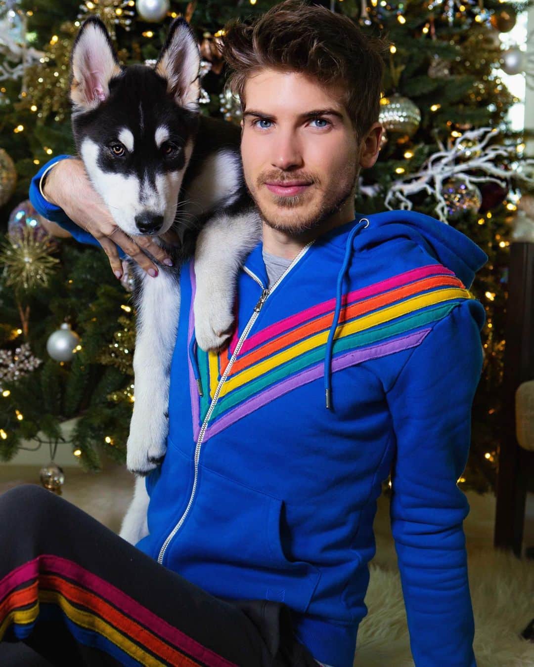 ジョーイ・グレーセッファのインスタグラム：「This Christmas, we ARE the gift 🎄 The new @crystalwolf holiday collection collab with @misterpreda is HERE! 🌈 You can now shop the iconic hoodie and sweats that we shared when we first started dating! If you know, you know! Enjoy 20% sitewide and bundles of the new hoodie & sweats include a mystery box with 3 free items, shop while they last! Link in bio ❤️」