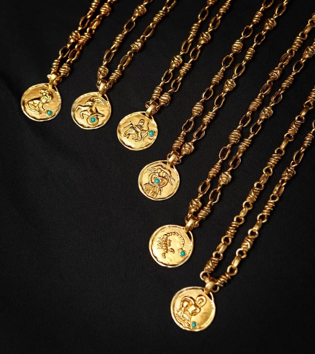 グーセンス パリのインスタグラム：「We are proud to unveil a collection of twelve zodiac signs medallions inspired by our archives. A recurring theme in the creations of Robert Goossens, founder of the House, astrological signs have been craftedhere ever since the 1950s, both as sculptures and as jewellery. Each medallion is sold with an iconic chain that has been interlaced and hammered. . . #Goossens #zodiac #medallions #yellow #gold #brass #turquoise」