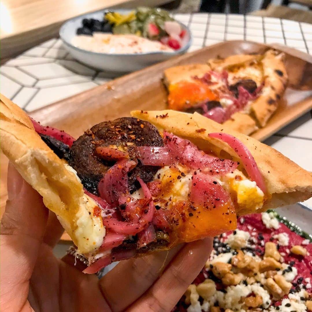 Eat With Steph & Coのインスタグラム：「Always been a fan of their brunch so of course had to check out the new branch of @brothermarcus_ in @oldspitalfieldsmarket!  Cosy vibes with their interiors and strong dinner menu. Loved the pide with satsouki and a 62 degree egg, and of course their well loved courgette fritters. The octopus came with a lovely chorizo mayo, and the taramasalata was delicious too. Basically a great place for food, and the Basilikum was a great cocktail, esp if you like basil cocktails like me 😍📸 @vernahungrybanana #invite #newopening #dinner #turkishfood #mediterranean #prettyfood #pizza #octopus #tomahawk #sogood #yum #timeoutlondon」