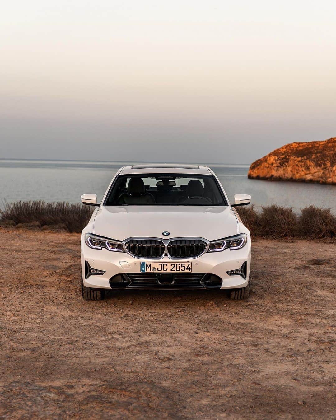 BMWのインスタグラム：「Electrified beach time. The BMW 3 Series Sedan. #THE3 #BMW #3Series @bmw_yachtsport __ BMW 330e Sedan: Energy consumption in kWh/100 km (combined): 15.4–14.8. Fuel consumption in l/100 km (combined): 1.9–1.6. CO2 emissions in g/km (combined): 43–37.  Acceleration (0-100 km/h): 5.9 s. Power: 215 kW, 292 hp, 420 Nm. Top speed (limited): 230 km/h.  The values of fuel consumptions, CO2 emissions and energy consumptions shown were determined according to the European Regulation (EC) 715/2007 in the version applicable at the time of type approval. The figures refer to a vehicle with basic configuration in Germany and the range shown considers optional equipment and the different size of wheels and tires available on the selected model. The values of the vehicles are already based on the new WLTP regulation and are translated back into NEDC-equivalent values in order to ensure the comparison between the vehicles. [With respect to these vehicles, for vehicle related taxes or other duties based (at least inter alia) on CO2-emissions the CO2 values may differ to the values stated here.] The CO2 efficiency specifications are determined according to Directive 1999/94/EC and the European Regulation in its current version applicable. The values shown are based on the fuel consumption, CO2 values and energy consumptions according to the NEDC cycle for the classification. Further information on official fuel consumption figures and specific CO2 emission values of new passenger cars is included in the following guideline: 'Leitfaden über den Kraftstoffverbrauch, die CO2-Emissionen und den Stromverbrauch neuer Personenkraftwagen' (Guide to the fuel economy, CO2 emissions and electric power consumption of new passenger cars), which can be obtained free of charge from all dealerships, from Deutsche Automobil Treuhand GmbH (DAT), Hellmuth-Hirth-Str. 1, 73760 Ostfildern-Scharnhausen and at https://www.dat.de/co2/.」