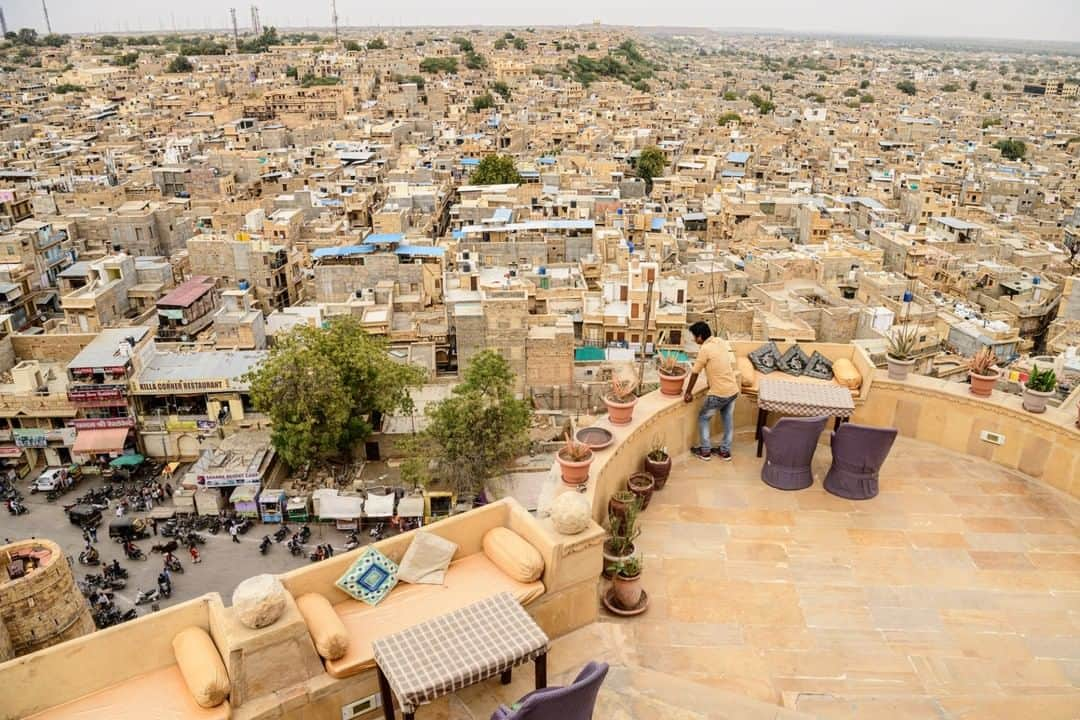 National Geographic Travelさんのインスタグラム写真 - (National Geographic TravelInstagram)「Photo by @jonathankingston | A man looks down from the wall of Jaisalmer Fort in Jaisalmer, India. Today roughly 7,000 modern windmills power the 12th-century sandstone desert city. #india #desert #jaisalmer #travel」1月4日 22時08分 - natgeotravel