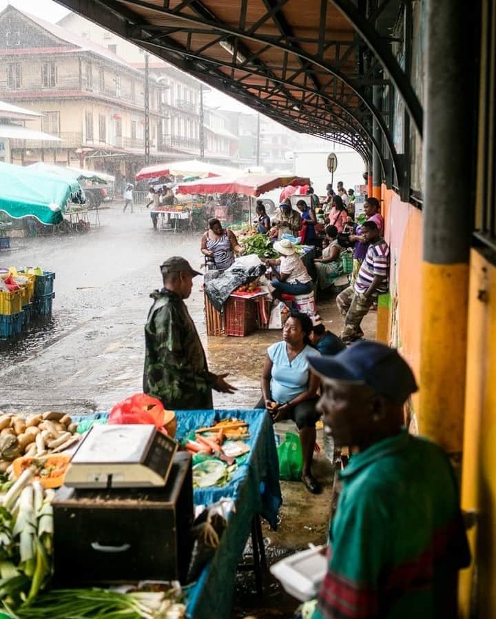 National Geographic Travelさんのインスタグラム写真 - (National Geographic TravelInstagram)「Photo by @robert_ormerod | Fruit and vegetable sellers take shelter from an intense rain shower at the central market in Cayenne, the capital of French Guiana. Inside the market the country’s diverse population of Creole, French, Haitian, Surinamese, Antillean, Chinese, Brazilian, and South Asian people bring an eclectic mix of offerings to the table. You can find piles of almost every spice, Amerindian basketry, African-style paintings and carvings, and soup stalls that serve up Vietnamese pho.」12月18日 22時07分 - natgeotravel