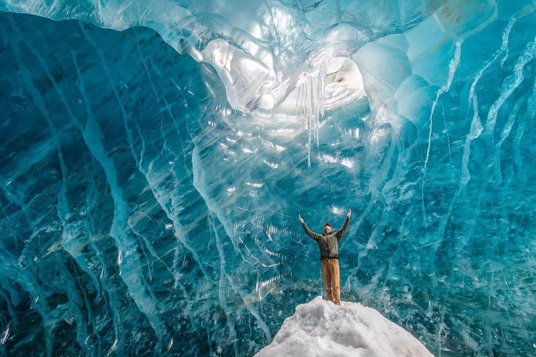 ナショナルジオグラフィックさんのインスタグラム写真 - (ナショナルジオグラフィックInstagram)「Photos by @paulnicklen | We had only less than an hour in the caves due to approaching weather, but they were spectacular. I kept asking Ryan Tidman to raise his arms into the air and pay homage to this magnificent cathedral of ice. I love ice. I have always loved ice. Sadly, these caves have now collapsed and are all but gone as our glaciers melt and recede. Let’s also look inward and ask ourselves what we can do daily to limit our impact on climate change. What are some of the things you do? Or, better yet, what are some of your goals? Let’s inspire one another to be better stewards of this planet. #FollowMe at @PaulNicklen for more photographs of our icy wonderlands.」12月27日 4時55分 - natgeo