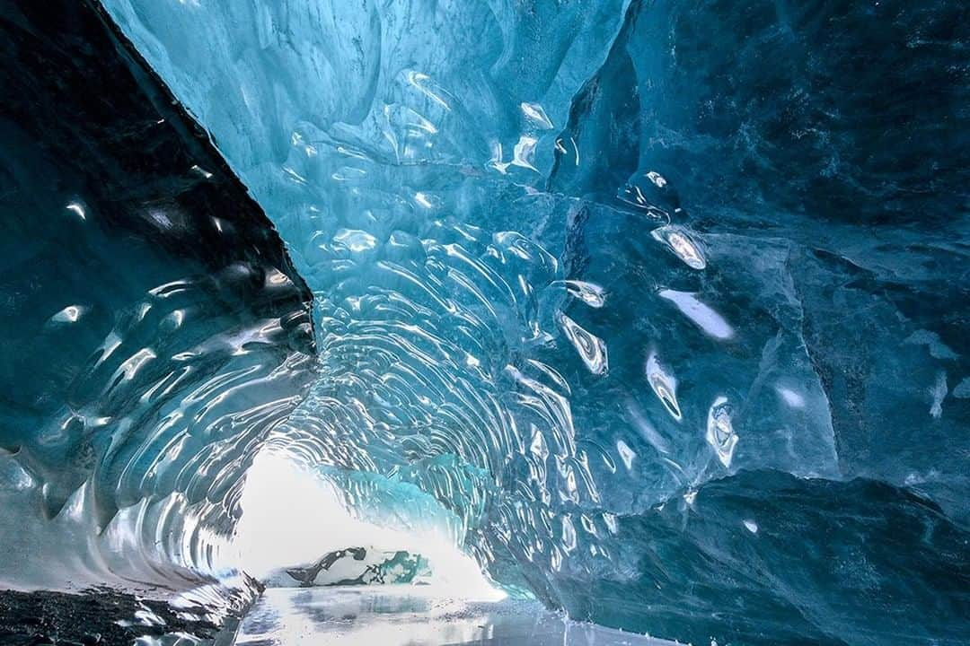 National Geographic Travelさんのインスタグラム写真 - (National Geographic TravelInstagram)「Photo by @daisygilardini | Traveling to Svalbard in early spring is cold, but it also gives you unique opportunities. The best time to visit glacier caves is during winter or early spring, when the ice melt slows because of the colder temperatures. The caves’ structures are more stable as a result. Glacial caves form inside the ice of a glacier and are shaped and carved by streams of meltwater. They often have scalloped, translucent walls that reflect blue light. Follow me @DaisyGilardini for more images and stories behind the scenes. #cave #ice #glaciercave #svalbard #Norway」12月30日 14時09分 - natgeotravel