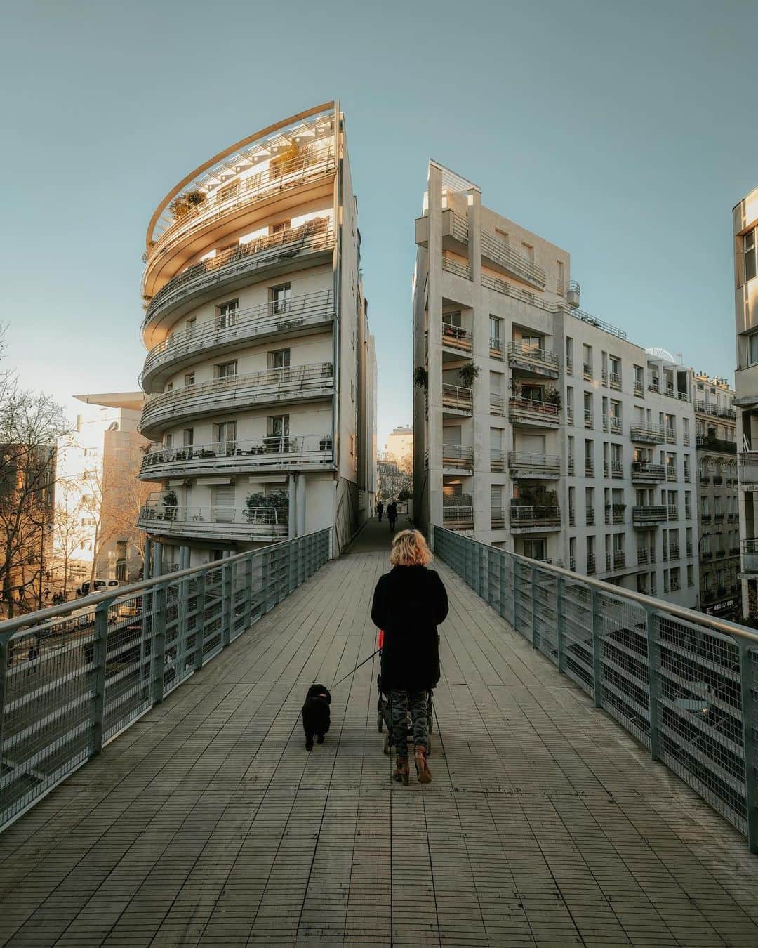 Putri Anindyaのインスタグラム：「a path in between // ⁣ ⁣ Paris is a special city with gorgeous vintage buildings in the center that look quite similar. This one is special. a pretty new building compared to the other ones across the street, yet it has its own charms. At the first moment it doesn’t look that cool whatsoever but once  I saw from this perspective turns out it’s not bad at all. Gladly this lady with her puppy passed me by and walked to the path in between. ⁣ ⁣ Taken with @realmeindonesia #realmex2pro 64mp #daretoleap」
