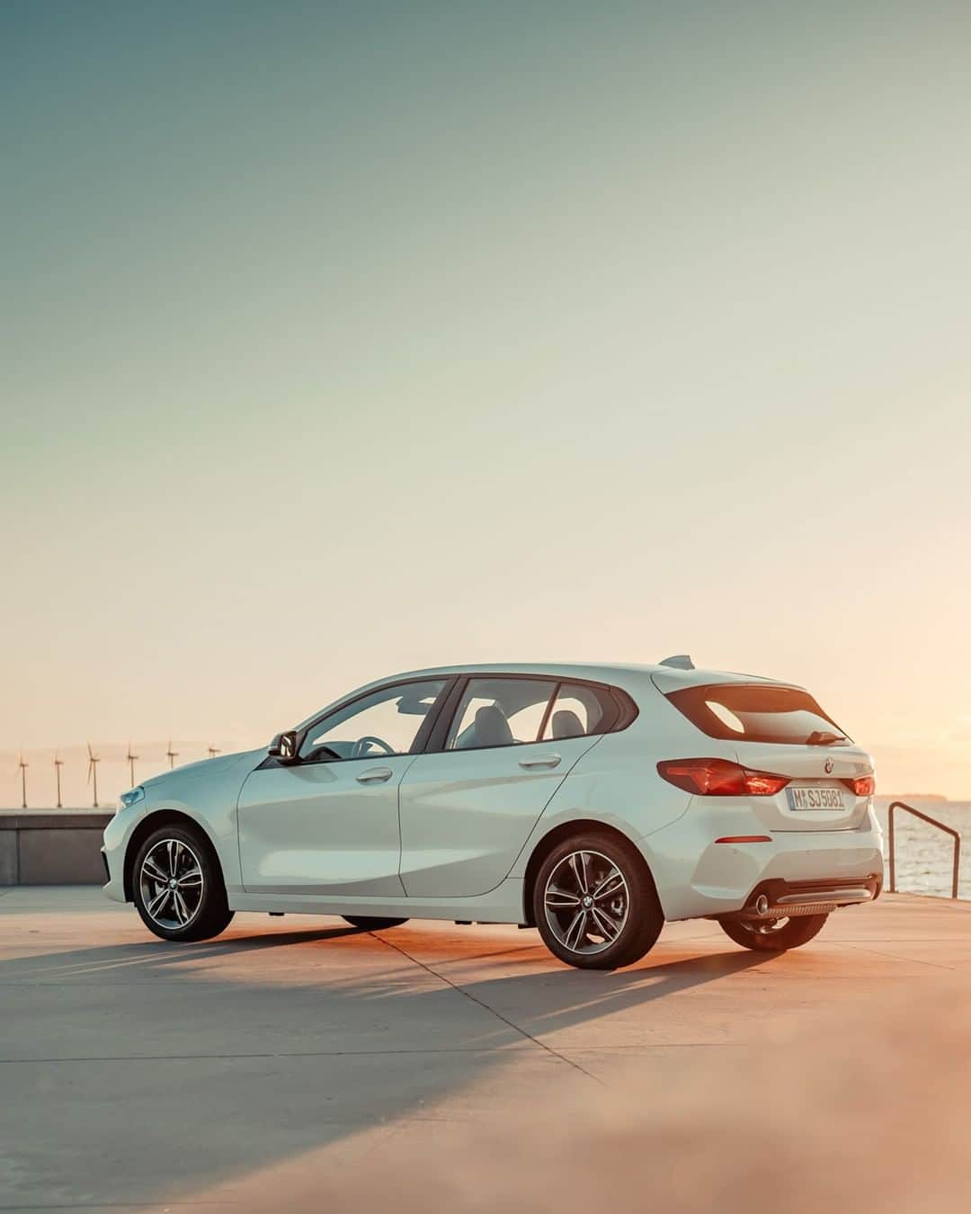 BMWのインスタグラム：「Welcoming the morning sun. The all-new BMW 1 Series. #THE1 #BMW #1Series  __ BMW 118i: Fuel consumption in l/100 km (combined): 5.7–5.3. CO2 emissions in g/km (combined): 129–121.  Acceleration (0-100 km/h): 8.5 s. Power: 103 kW, 140 hp, 220 Nm. Top speed (limited): 213 km/h.  The values of fuel consumptions, CO2 emissions and energy consumptions shown were determined according to the European Regulation (EC) 715/2007 in the version applicable at the time of type approval. The figures refer to a vehicle with basic configuration in Germany and the range shown considers optional equipment and the different size of wheels and tires available on the selected model. The values of the vehicles are already based on the new WLTP regulation and are translated back into NEDC-equivalent values in order to ensure the comparison between the vehicles. [With respect to these vehicles, for vehicle related taxes or other duties based (at least inter alia) on CO2-emissions the CO2 values may differ to the values stated here.] The CO2 efficiency specifications are determined according to Directive 1999/94/EC and the European Regulation in its current version applicable. The values shown are based on the fuel consumption, CO2 values and energy consumptions according to the NEDC cycle for the classification. Further information on official fuel consumption figures and specific CO2 emission values of new passenger cars is included in the following guideline: 'Leitfaden über den Kraftstoffverbrauch, die CO2-Emissionen und den Stromverbrauch neuer Personenkraftwagen' (Guide to the fuel economy, CO2 emissions and electric power consumption of new passenger cars), which can be obtained free of charge from all dealerships, from Deutsche Automobil Treuhand GmbH (DAT), Hellmuth-Hirth-Str. 1, 73760 Ostfildern-Scharnhausen and at https://www.dat.de/co2/.」