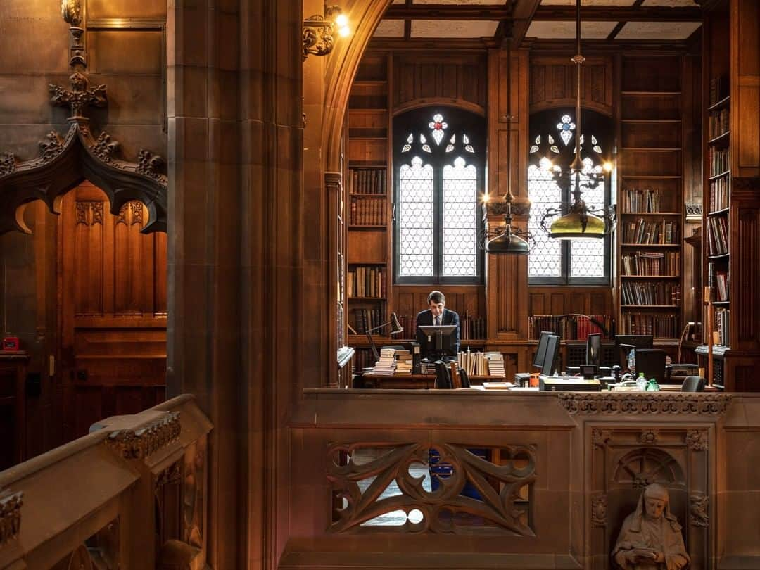 National Geographic Travelさんのインスタグラム写真 - (National Geographic TravelInstagram)「Photo by @paoloverzone | John Hodgson, joint head of special collections, stands in the old “art alcove” of the John Rylands Library at the University of Manchester in England. The Historic Reading Room is the heart of the library, traditionally where people would have studied the collections, but now given over to visitors. As the centerpiece of the library, it is filled with general books, many of them from the Spencer collection (of Diana, Princess of Wales), one of the foundation collections. Hodgson says of the library, “This is not a museum—it is a working and living library that is collecting all the time, with visiting scholars from all over the world. It is a working collection. A lot of the work happens out of sight from the general public. The collections are here to be used. What the public sees is the tip of the iceberg.” The books are intrinsic to the architecture of the building. #manchester #johnrylandslibrary  Follow @paoloverzone for more photos and stories.」1月8日 18時08分 - natgeotravel