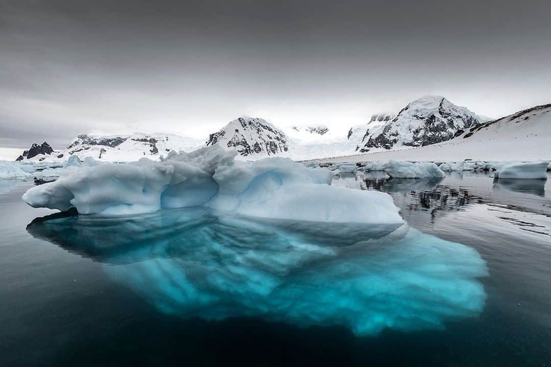 National Geographic Travelさんのインスタグラム写真 - (National Geographic TravelInstagram)「Photo by @daisygilardini | I simply love Antarctica’s dark gray skies. Not only do they add drama to an already stunning landscape, but they act as a giant softbox light diffuser that enables the colors of the ice to intensify through the water. Follow me @DaisyGilardini for more images and stories behind the scenes. #antarctica #iceberg #ice #climatechange」1月13日 14時09分 - natgeotravel