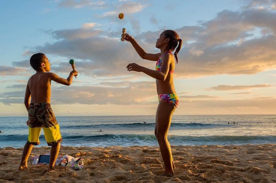 National Geographic Travelさんのインスタグラム写真 - (National Geographic TravelInstagram)「Photo by Cristina Mittermeier @Mitty | After school, the kids of the Hawaiian town of Mãkaha spend their afternoons at the beach, surfing and hanging out with family and friends. They jump in the small waves, surf the big ones, or play with a “kendama,” a Japanese toy. Known as "bolero" in my home country of Mexico, kendama is a fun game that promotes competition, hand-eye coordination, and quick reflexes to avoid the occasional bump to the head. Who could ask for a better playground?  Follow me @Mitty to find out why Hawaii is one of my favorite places in the world, and for more images that celebrate the relationships between coastal peoples and the ocean. #Ohana #Sunset #TheSeaIsLife #Hawaii #HumansoftheOcean」1月17日 10時05分 - natgeotravel