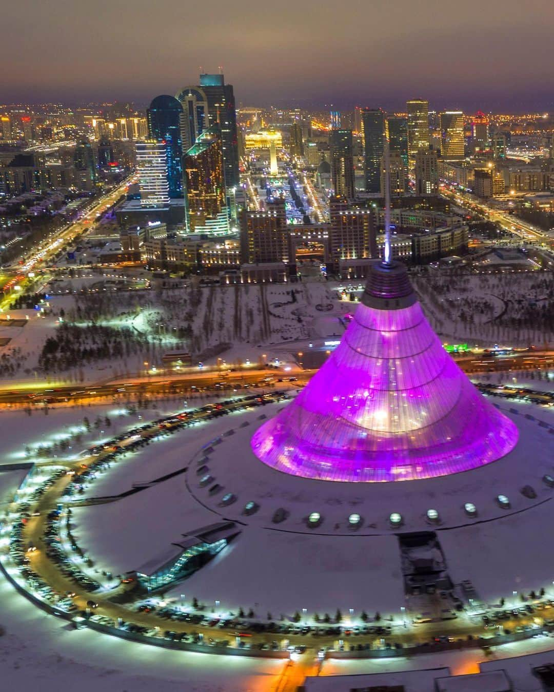 National Geographic Travelさんのインスタグラム写真 - (National Geographic TravelInstagram)「Photo by George Steinmetz @geosteinmetz | Welcome to Tomorrowland in Nur-Sultan, the renamed capital of Kazakhstan. In the foreground is the Khan Shatyr Entertainment Center, built under the world’s largest tent structure, which includes a shopping mall, amusement park rides, and even an indoor beach on the top floor. To view more of our world from above, follow @geosteinmetz.」1月18日 2時37分 - natgeotravel