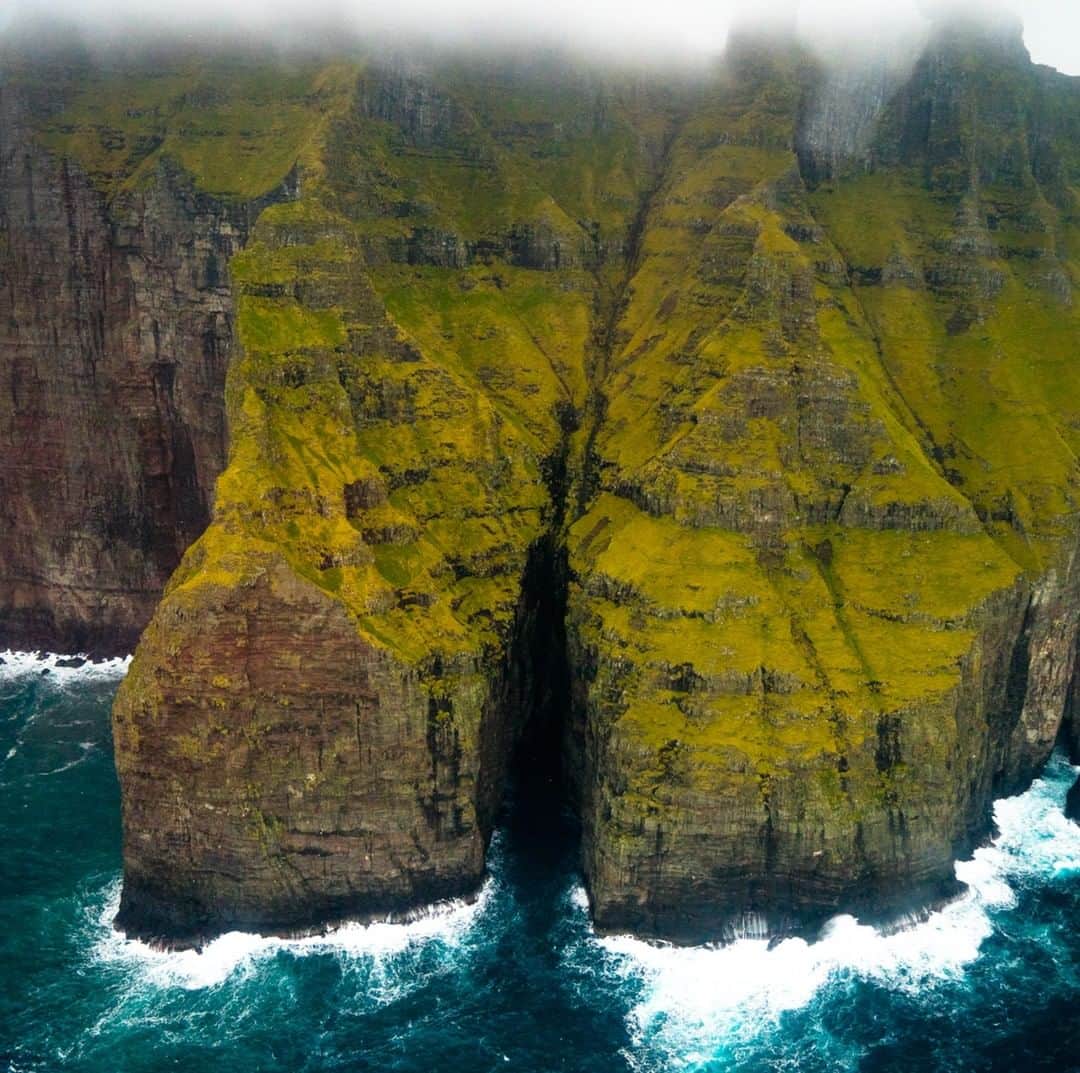 National Geographic Travelさんのインスタグラム写真 - (National Geographic TravelInstagram)「Photo by @chrisburkard | The sea cliffs of the Faroe Islands are the tallest in Europe and some of the highest in the world. It’s almost as if they are guarding the islands from modern society, making this place feel ancient and virtually untouched. The islands rest almost exactly halfway between Iceland and Norway, a stone’s throw away from the Arctic Circle. On shore, the climate is too harsh to support agriculture, so the Faroese get by on a diet of mainly sheep and fish. Growing up on the central coast of California, I have never experienced anything close to what the Faroese people have, with access to all kinds of food and amenities on a daily occurrence. This is why traveling to such remote places can be extremely humbling and rewarding, to gain a better perspective on the endurance of the human spirit.」1月20日 14時09分 - natgeotravel