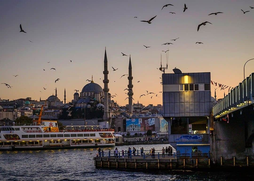 のインスタグラム：「Photo by @dina_litovsky | This was taken on my first visit to Istanbul. Standing by the Galata Bridge, the gorgeous sunsets of the city took my breath away. Dubbed the City of Minarets, Istanbul is home to thousands of mosques, including the Yeni Cami, or New Mosque, pictured here, which this year celebrated its 356th birthday. For more images, follow me @dina_litovsky.」