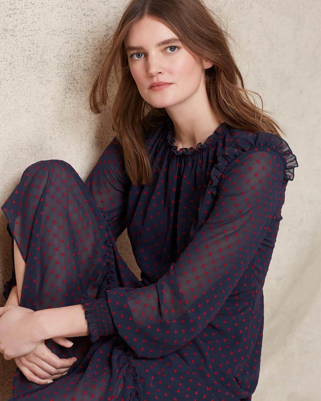 ローラアシュレイのインスタグラム：「Taking inspiration from the Laura Ashley archive a charming ruby heart print dances across a softly frilled dress in our beautiful curated collection—Alderney.」