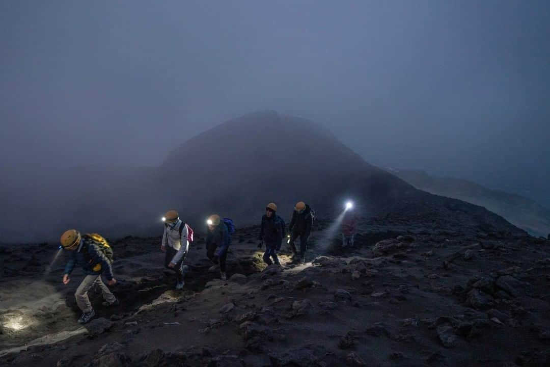 National Geographic Travelさんのインスタグラム写真 - (National Geographic TravelInstagram)「Photo by @andrea_frazzetta | The best time to climb Stromboli is in the evening, at sunset. During the day it's too hot. The climb lasts for about four hours. At the beginning you proceed slowly, but in the end, when you are almost at the top, you have to climb, exhausted. By nightfall everything around you becomes dark. The steps are slow. And the Earth, made of lava beneath your feet, is a metallic mirror that reflects the light of the moon.  In this picture a group of tourists is on an excursion to the top of the volcano. Located in the middle of the Tyrrhenian Sea, north of the Sicilian coast, Stromboli is a small island dominated by one of the most active volcanoes in the world.  To see more photos from this story and from my travels, follow me @andrea_frazzetta. #stromboli #volcano #italy」2月23日 10時09分 - natgeotravel