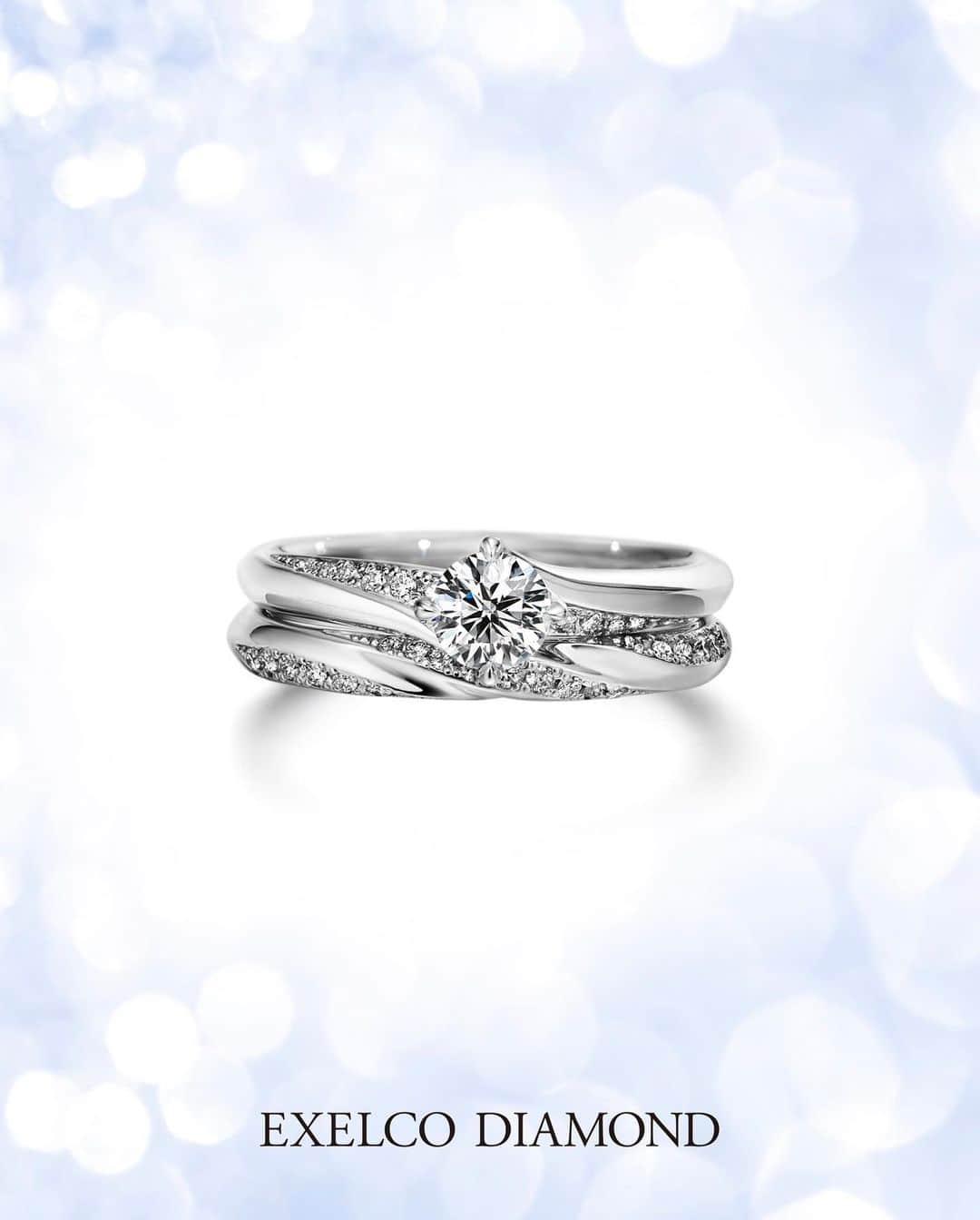 エクセルコ ダイヤモンド 婚約指輪♔結婚指輪のインスタグラム：「EXELCO DIAMONDでは、 輝きを引き立たせるセットリングを多数 ご用意しております。 〝Chance Eternelle〟シャンス エターナル .  圧倒的な輝きのダイヤモンドが 上昇しながら永遠に繋がっていく。 誓った二人のこれからにはさらに 輝く未来が待っている、という意味を込めた  輝きをふんだんに愉しめるデザインです。 . 店舗一覧 東京本店/盛岡店/仙台店/新潟店/青山店/町田マルイ店/横浜店/みなとみらい店/大宮店/ 宇都宮店/高崎店/ららぽーと沼津店/静岡店/浜松店/金沢店/長野店/松本店/名古屋本店/大阪店/ 梅田店/京都店/神戸店/広島店/福岡店/ヒルトン福岡シーホーク店/小倉店/博多店/長崎ハマクロス411店/熊本店 . #exelcodiamond  #エクセルコダイヤモンド #ファッションジュエリー」