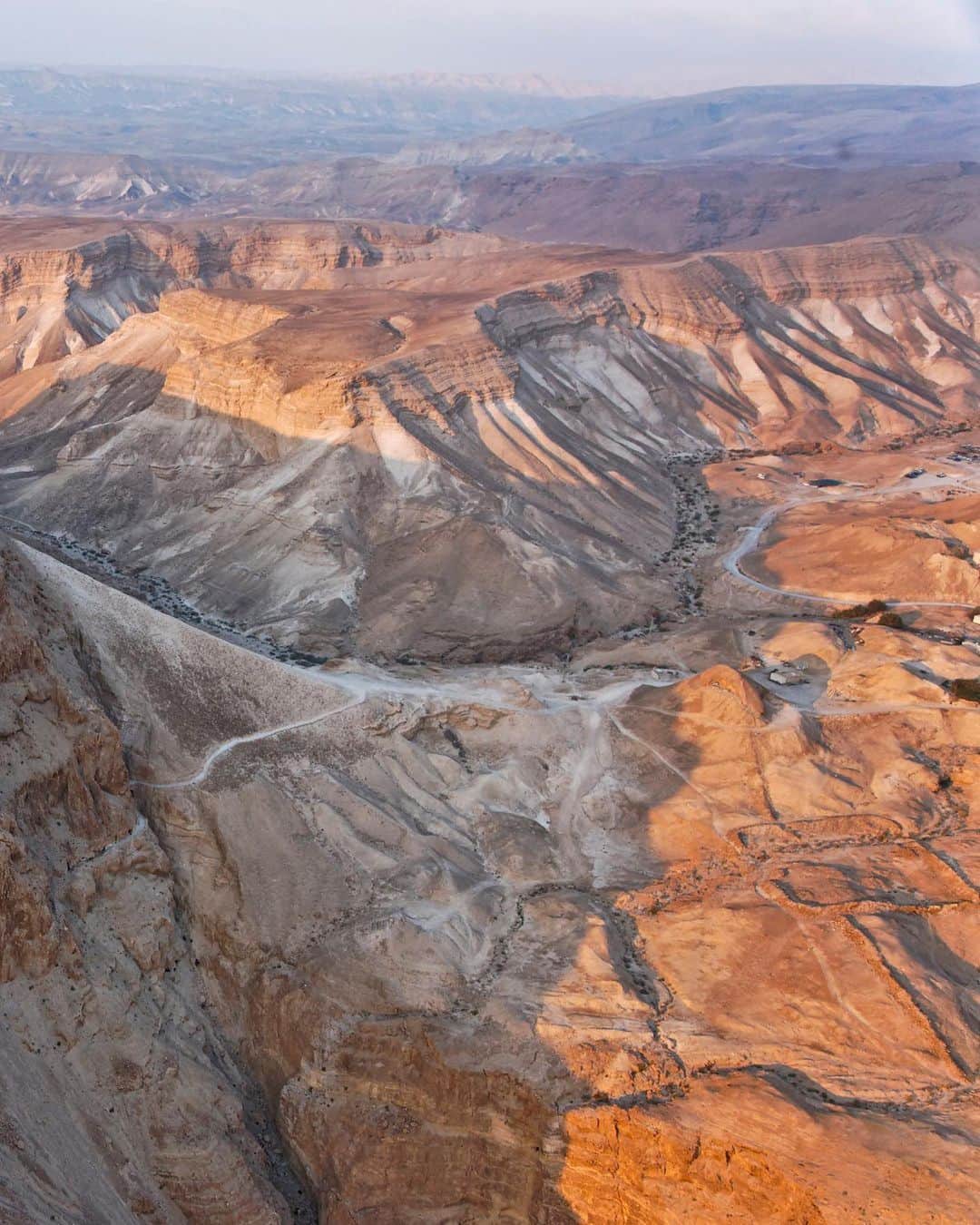 National Geographic Travelさんのインスタグラム写真 - (National Geographic TravelInstagram)「Photo by George Steinmetz @geosteinmetz | Masada, the ancient Jewish citadel, has become a symbol for the state of Israel. It was besieged in A.D. 70 by the Romans, who encircled it before building an earthen ramp (seen at right) to capture it from its determined Jewish inhabitants. The defenders are said to have died in a mass suicide rather than submit to Roman rule, but the truth of what happened there may never be known.  To explore more of our Earth from above, follow @geosteinmetz. #paramotor」2月4日 6時23分 - natgeotravel