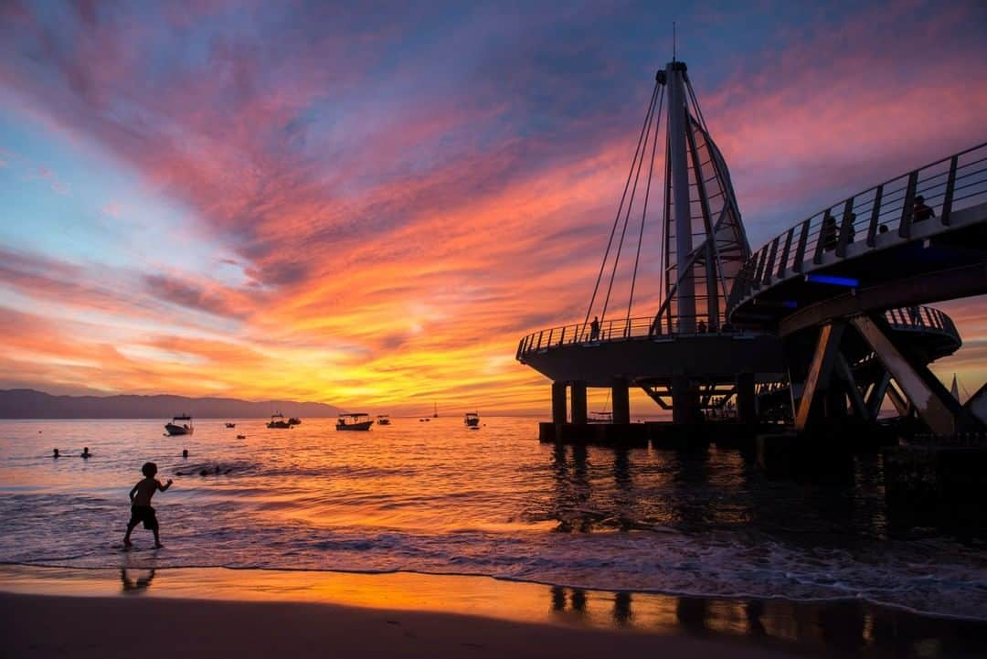 National Geographic Travelさんのインスタグラム写真 - (National Geographic TravelInstagram)「Photo by @KristaRossow | When the sky appeared to catch fire in Puerto Vallarta, Mexico, I was grateful for the iconic pier at Playa de los Muertos and a few swimmers still splashing about to make for interesting silhouettes in the foreground.  Follow me @KristaRossow for more images from around the world. #Mexico #sunset #PuertoVallarta」2月13日 14時10分 - natgeotravel