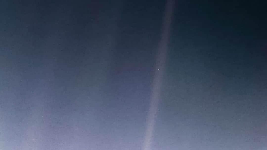 NASAさんのインスタグラム写真 - (NASAInstagram)「"Look again at that dot. That's here. That's home. That's us." – Carl Sagan  A newly processed version of the iconic ‘Pale Blue Dot’ image shows Earth 4 billion miles away from our Voyager 1 spacecraft, taken on #ValentinesDay 1990.  The updated image uses modern image-processing software and techniques while respecting the intent of those who planned the image. Like the original, the new color view shows Planet Earth as a single, bright blue pixel in the vastness of space. Rays of sunlight scattered within the camera optics stretch across the scene, one of which happens to have intersected dramatically with Earth.  Click the link in our bio to download a 'Pale Blue Dot' poster.  #nasa #space #valentine #voyager #earth」2月15日 6時24分 - nasa