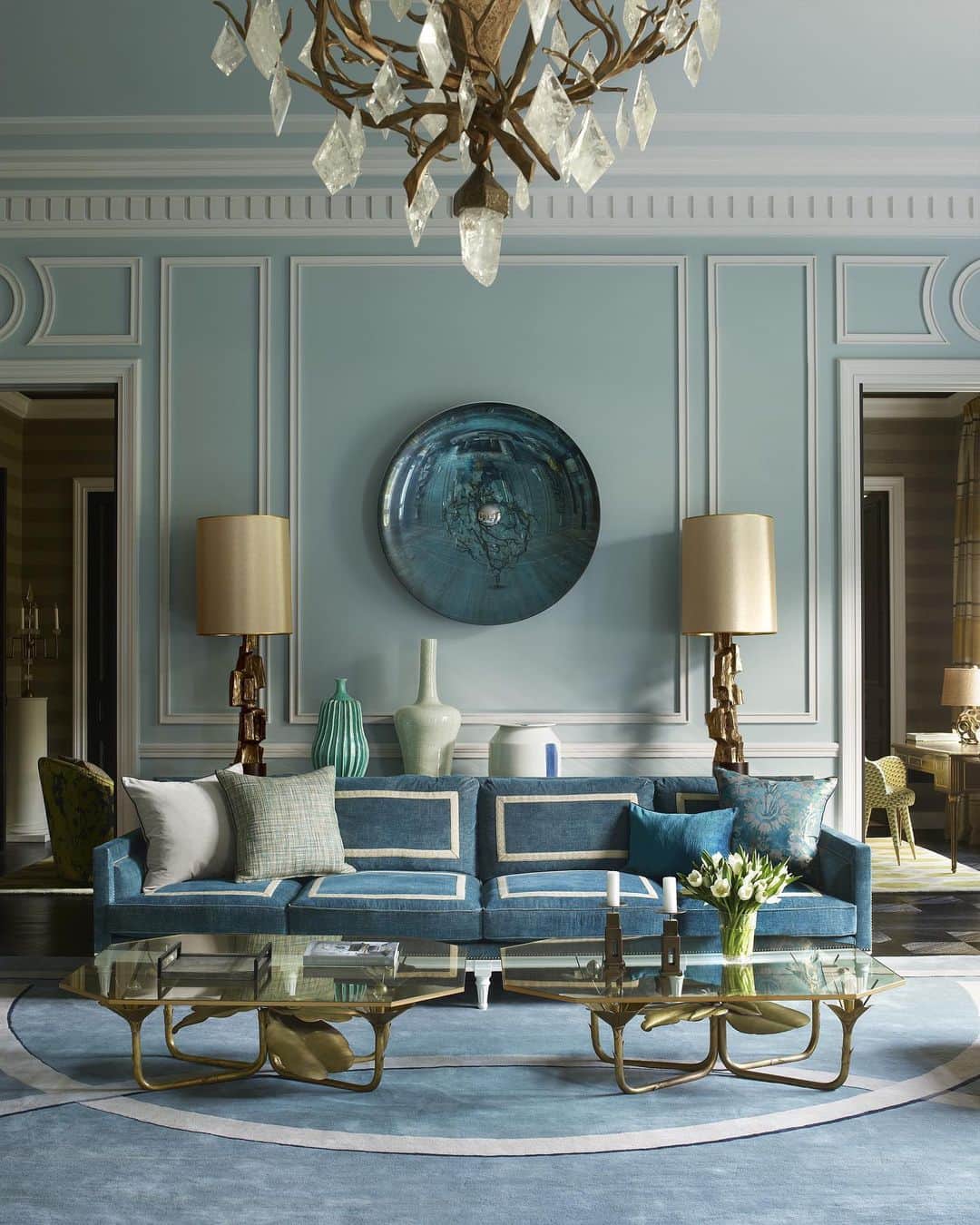 ELLE DECORさんのインスタグラム写真 - (ELLE DECORInstagram)「When it came to designing a Middle Eastern princess' first apartment in Paris, A-Lister Jean-Louis Deniot didn't think twice about filling the space with an abundance of color. The inviting living room, featuring an array of blues, is furnished with a sofa by Collection Pierre that is upholstered in a @brochier.fabrics design with ribbons by @samuelandsons. The lamps by Paul Evans flank a glass wall sculpture by Christophe Gaignon, the cocktail tables are custom designs, and the walls are painted in Paint Library's Eucalyptus.  Photo by @simonuptonphotos and produced by @cynthiaefrank, from the ED archive. Click the link in our bio for the full home tour.」2月19日 7時04分 - elledecor