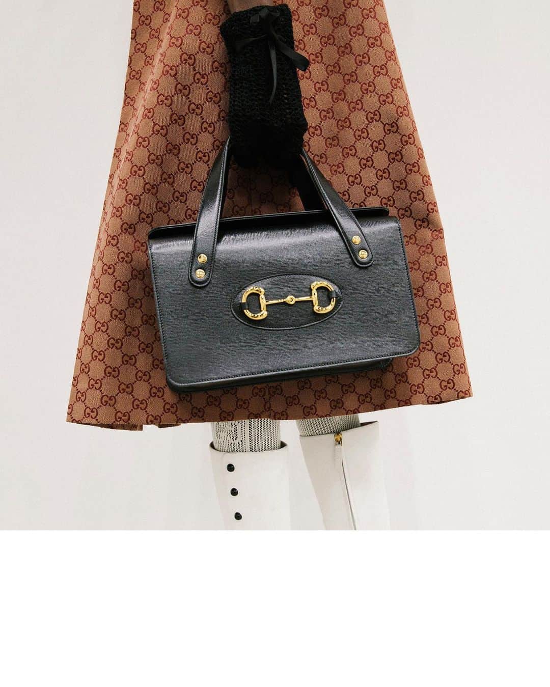 のインスタグラム：「Crafted in a new shape with long top handles, the #Gucci1955Horsebit bag is worn with a GG motif dress coat and white leather boots with contrast black buttons, in an image seen in fittings before the women’s #GucciFW20 fashion show by @alessandro_michele at the #GucciHub. #AlessandroMichele #mfw #GucciTheRitual Watch the show through link in bio.」
