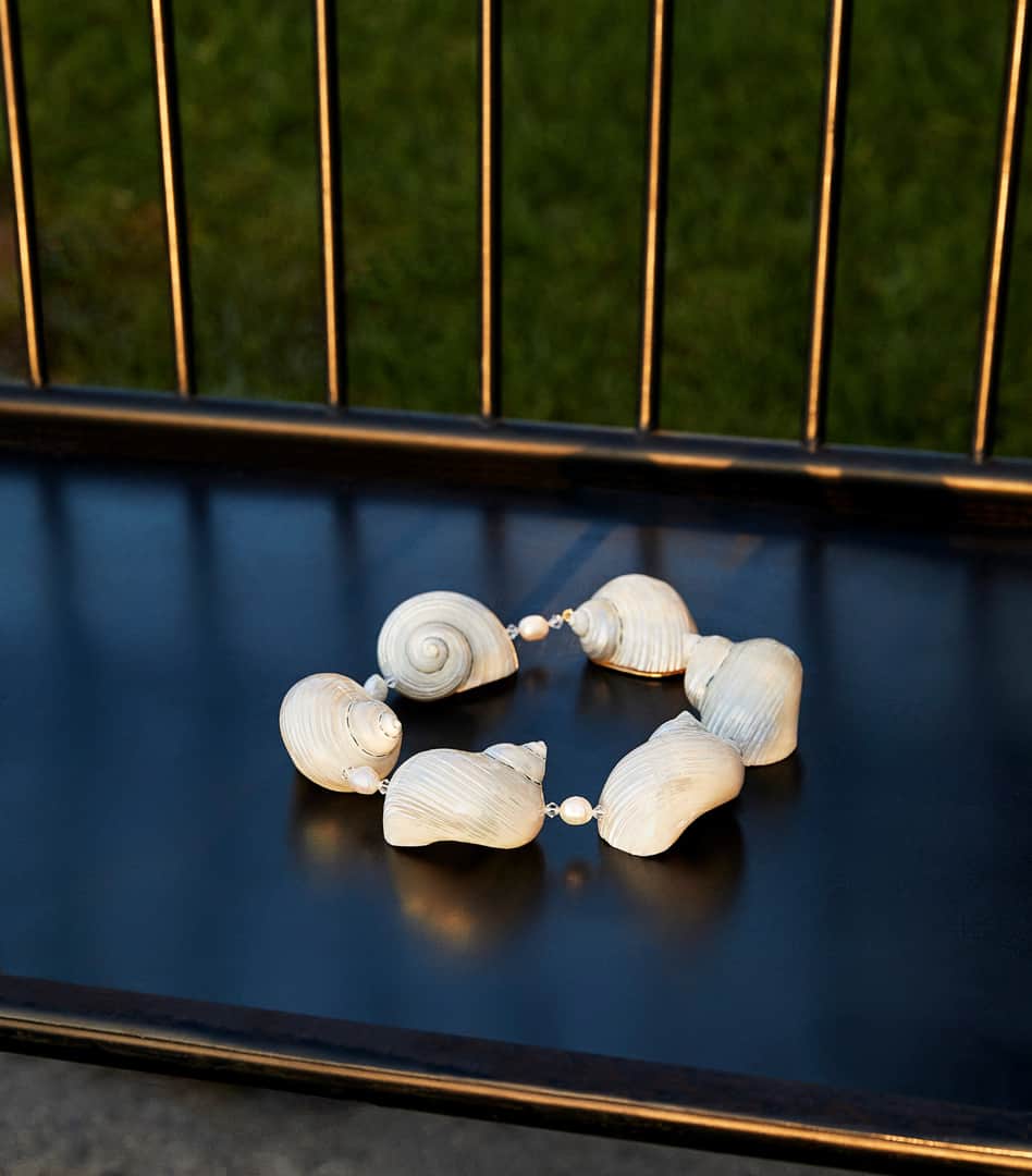 プラダさんのインスタグラム写真 - (プラダInstagram)「Natural light: a necklace of polished natural shells, baroque natural pearls, rock crystals, and gold-plated silver. Discover more via link in bio. Creative direction @ferdinandoverderi Styling #olivierrizzo #PradaSS20 #Prada」3月21日 11時14分 - prada