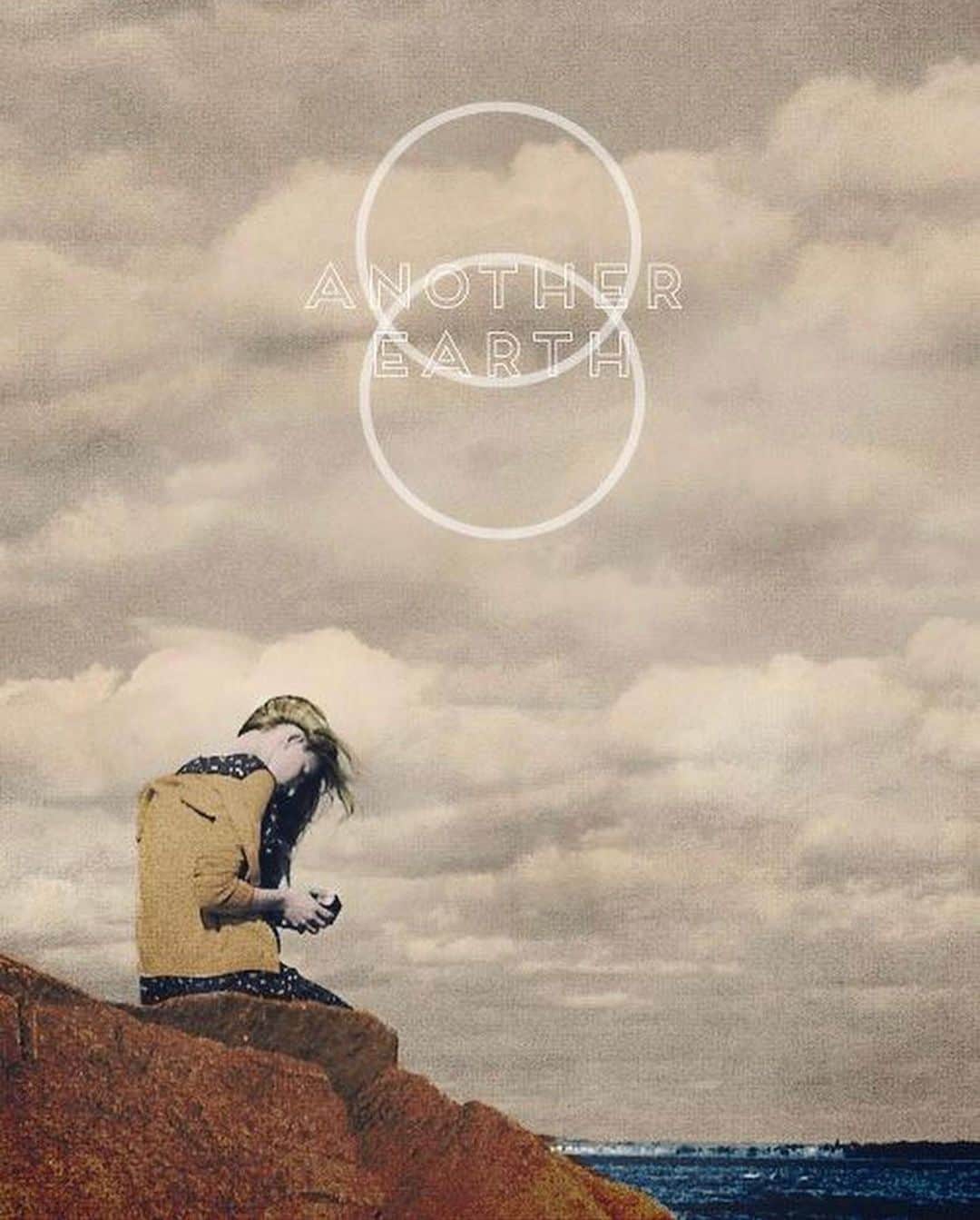 ブリット・マーリングのインスタグラム：「someone shared this with me — art made for the film #anotherearth which @_mikecahill and I wrote together and he directed.  We had never made a feature fiction work before. We started shooting it at Mike’s mom’s house with just my sister Morgan and our friend Liang as crew. A crew of 4 for two weeks in the snow.  We shot the final sequence of the film that way with some fabric we got from Michael’s craft store as our green screen.  Then the wonderful producer  @huntercgray joined us and helped secure funds and other cast and resources to shoot the majority of the film. But we were never more than a crew of 12 for most of shooting and the budget was around 100k.  It remains one of my favorite experiences of filmmaking.  I think a lot about how there is no place to get to with making art.  No center or stage or honor that will hold.  Nothing to arrive at.  In fact, if anything, you are often chasing the feelings you had when you made work for the first time. When you didn’t know anything and were acting from instinct, desire and love.  You sometimes hear ppl use the word amateur as if it’s a dirty word. As if not being a paid professional means it isn’t for real or doesn’t count. But amateur is from the Greek root “ama” — to do something for the love of it.  And I think that’s the intangible thing inside art that actually stirs something in us.  In these strange times when so much has been put on pause it feels to me like a good moment to take time to do things for the love of it and especially to do things for others in need for the love of it.  If you know who made this “amateur” poster — shout it out 🤍」