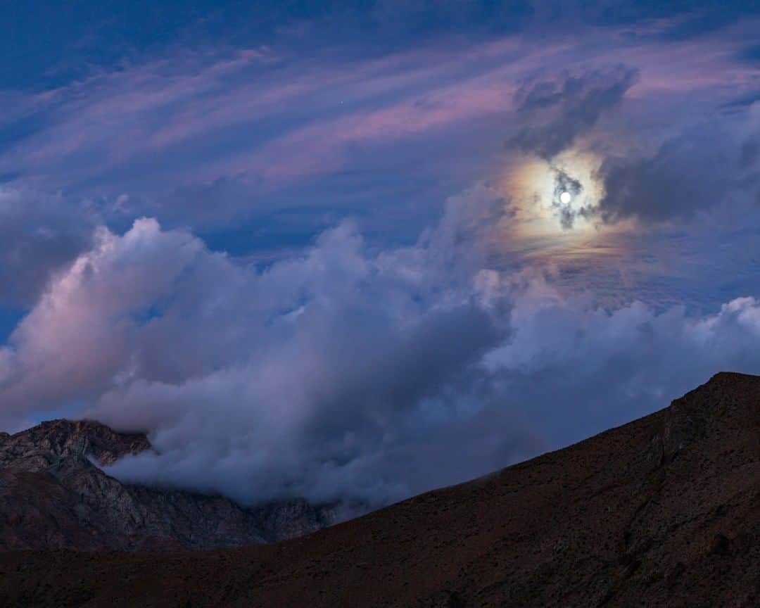 National Geographic Travelさんのインスタグラム写真 - (National Geographic TravelInstagram)「Photo by @BabakTafreshi | Even a cloudy night like this can be magical. A moonlit evening in the Elqui Valley of Chile, known for its wine, nature, and pristine night sky. The moon passing behind thin clouds forms a colorful atmospheric corona.  Explore more of the World at Night with me @babaktafreshi. #elquivalley #moonlight #nightscape #twanight」2月27日 22時07分 - natgeotravel