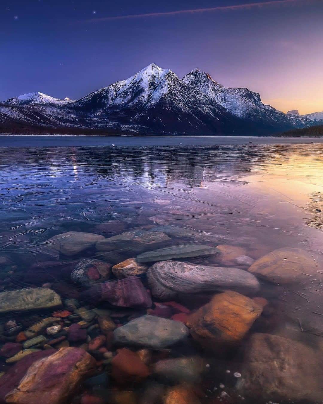 Discover Earthさんのインスタグラム写真 - (Discover EarthInstagram)「A calm sunrise at Glacier National Park in summer (photo 1) and winter (photo 2). " The clear waters and perfect reflection was everything I had hoped for. What an incredibly beautiful and peaceful moment." 🇺🇸 #DiscoverUnitedStates Photos and caption by @k_rowejo」3月13日 21時22分 - discoverearth