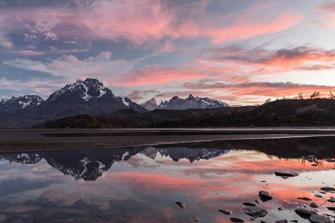 National Geographic Travelさんのインスタグラム写真 - (National Geographic TravelInstagram)「Photo by @daisygilardini | On this day, while on assignment in Chile’s Torres del Paine National Park, the magic happened! We had the right amount of clouds and they were at different altitudes. It’s great when this happens because, depending on the altitude, the clouds catch the first rays of sun at different times. That causes different hues, giving the image more depth. When photographing sunrises and sunsets, I always hope for some cloud formations in the sky. It has to be the right amount, though. Too few clouds will result in a boring image. Too many will obscure the sunrise or sunset entirely. Follow me @DaisyGilardini for more images and stories behind the scenes. #torresdelpainenationalpark #sunset #landscaphotography #chile」3月15日 9時05分 - natgeotravel